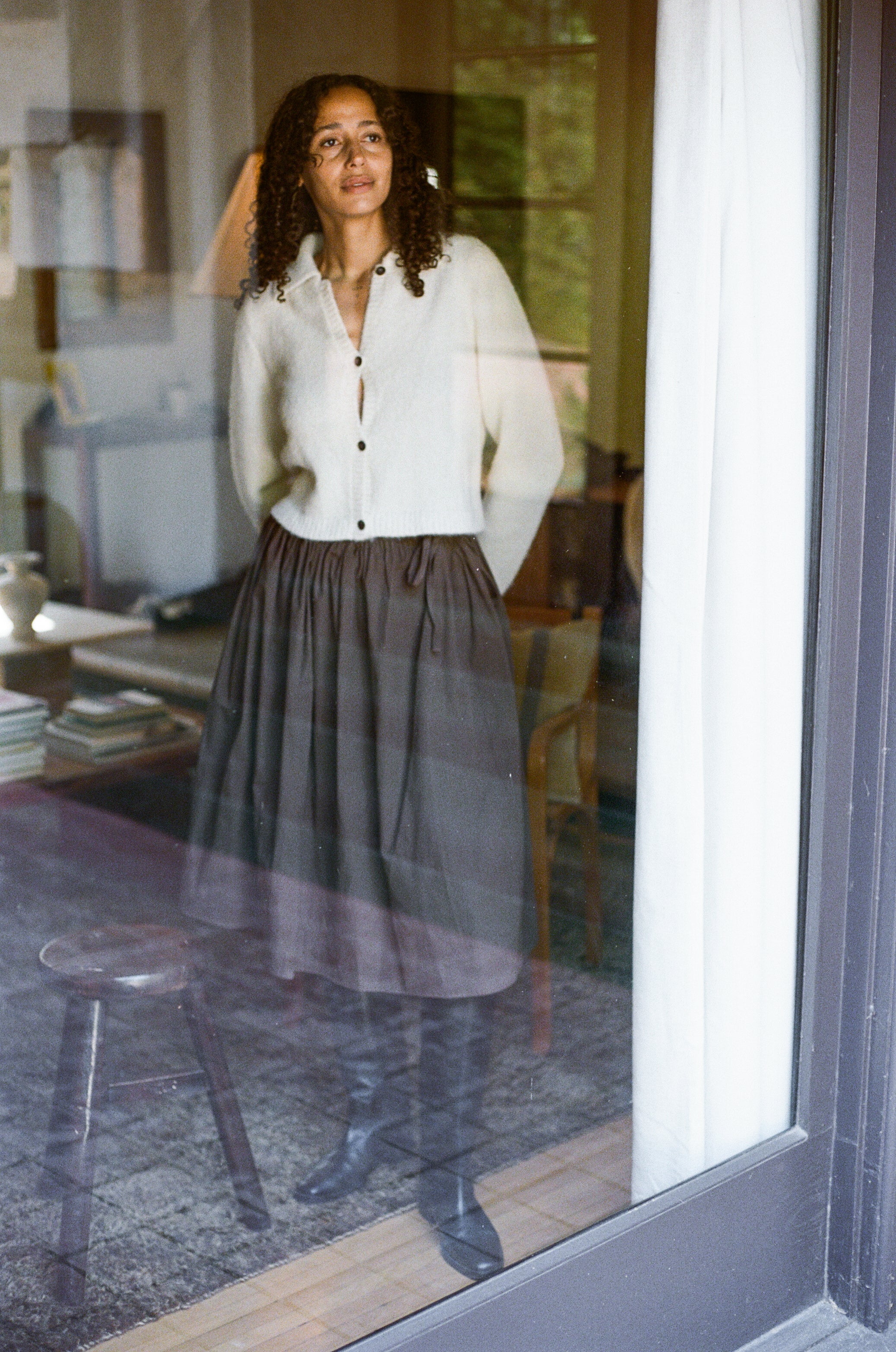 Model wears tall black riding boot with almond shaped toe.