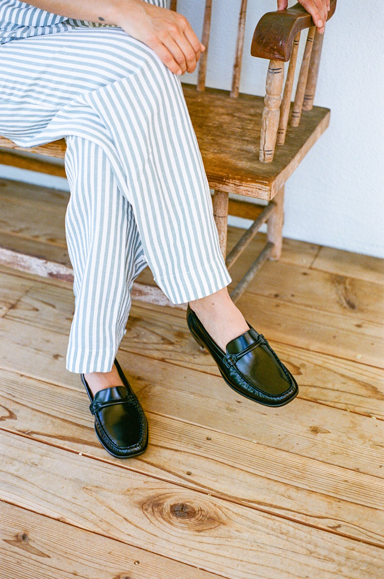 Model wears loafer in black smooth leather.