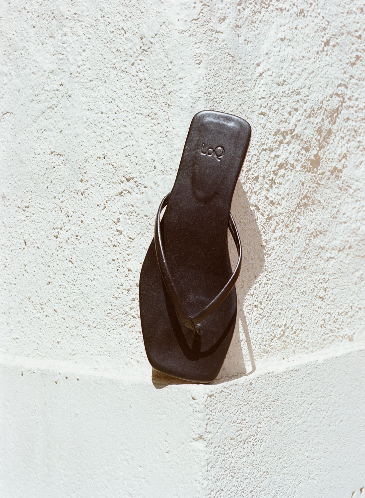 Minimal black flip flop style thong sandal.