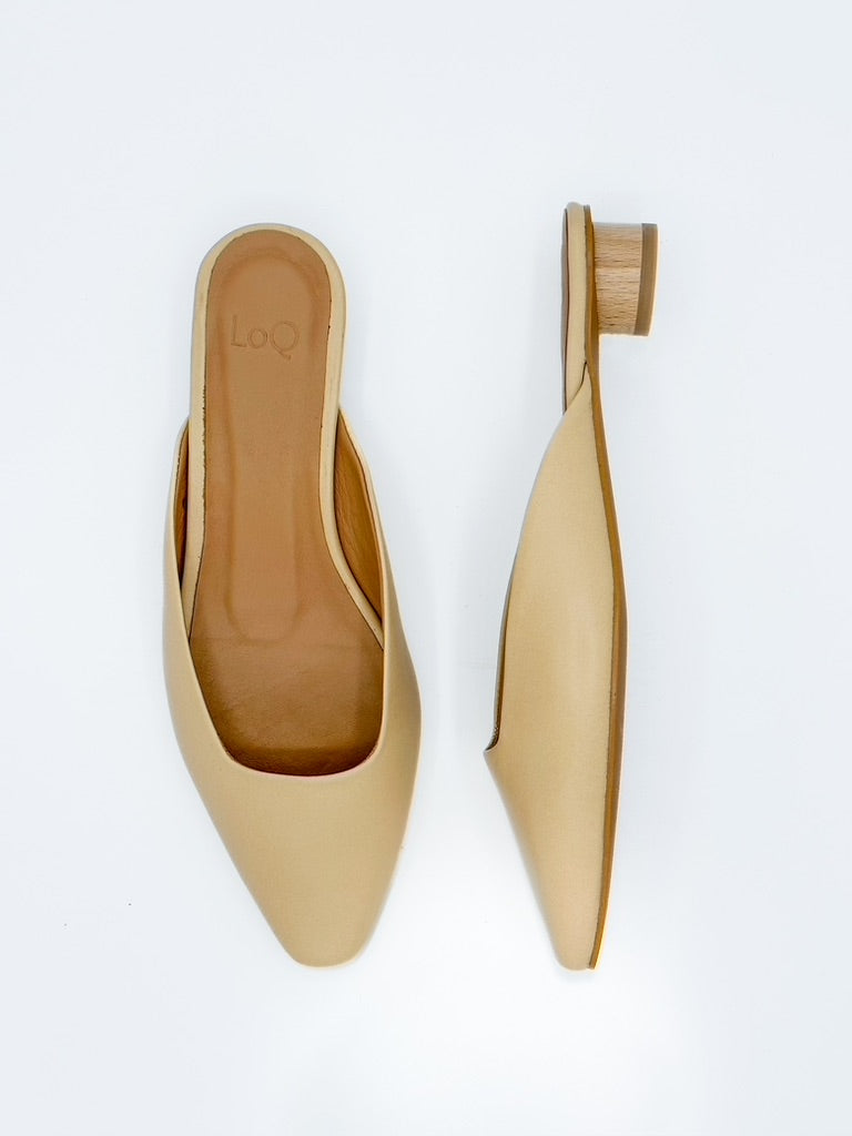 Beige mule shoes with a pointed toe and short heel