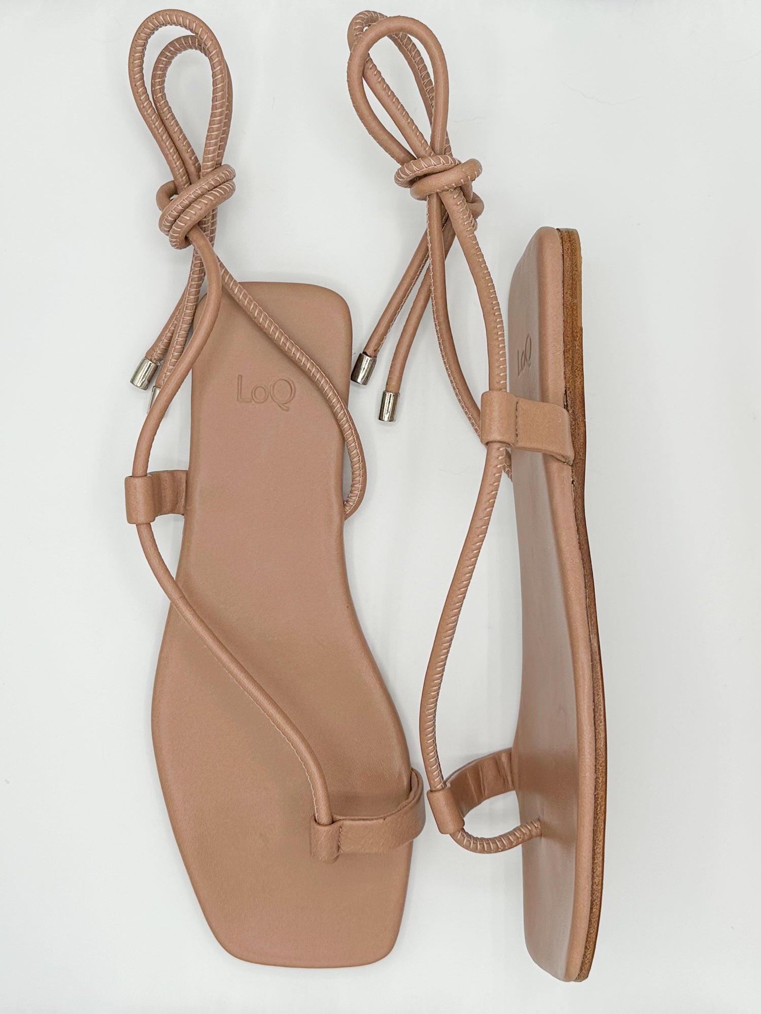 Tan colored ankle wrap sandals.
