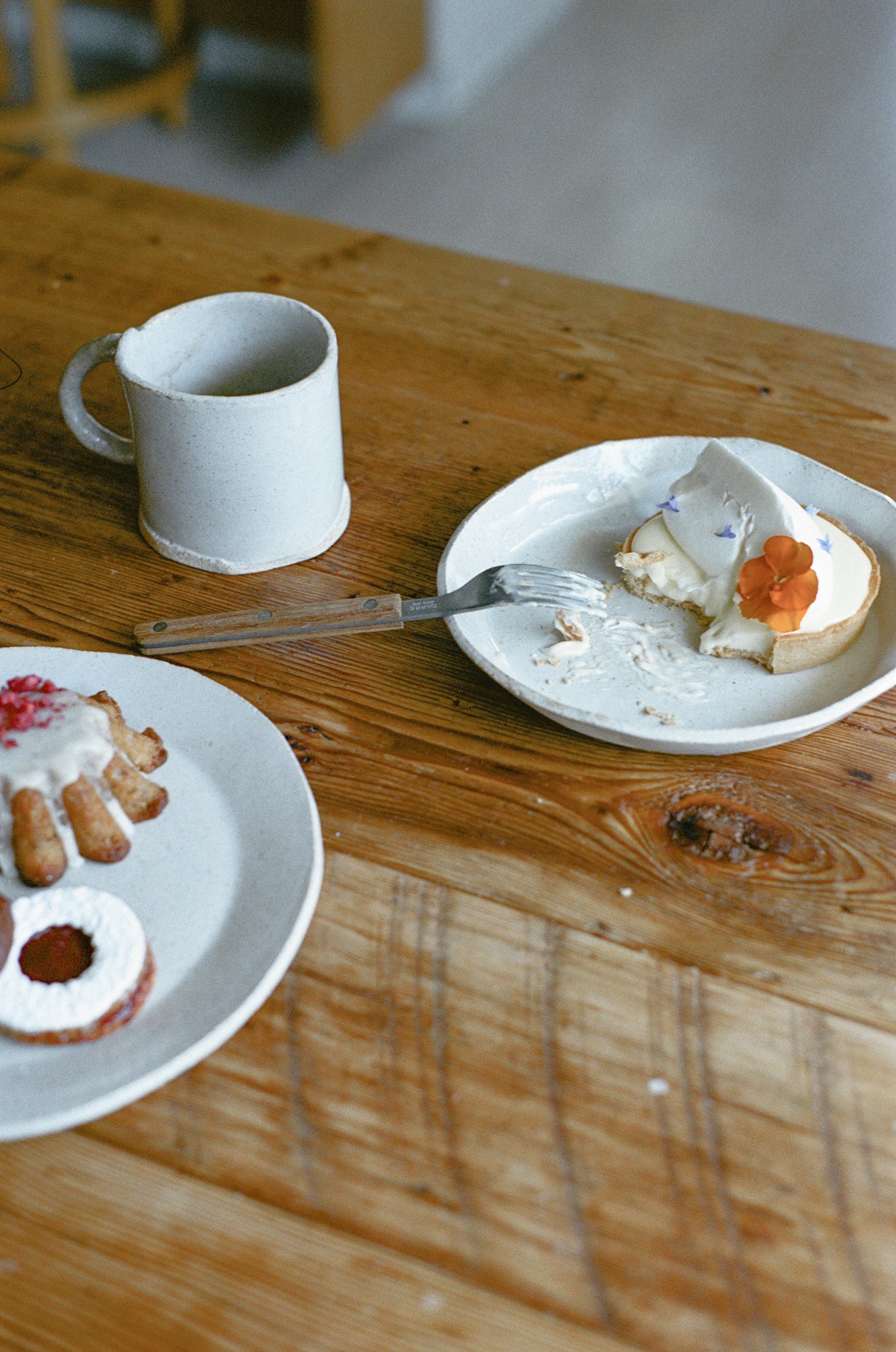 Table with white ceramic mug and plates.