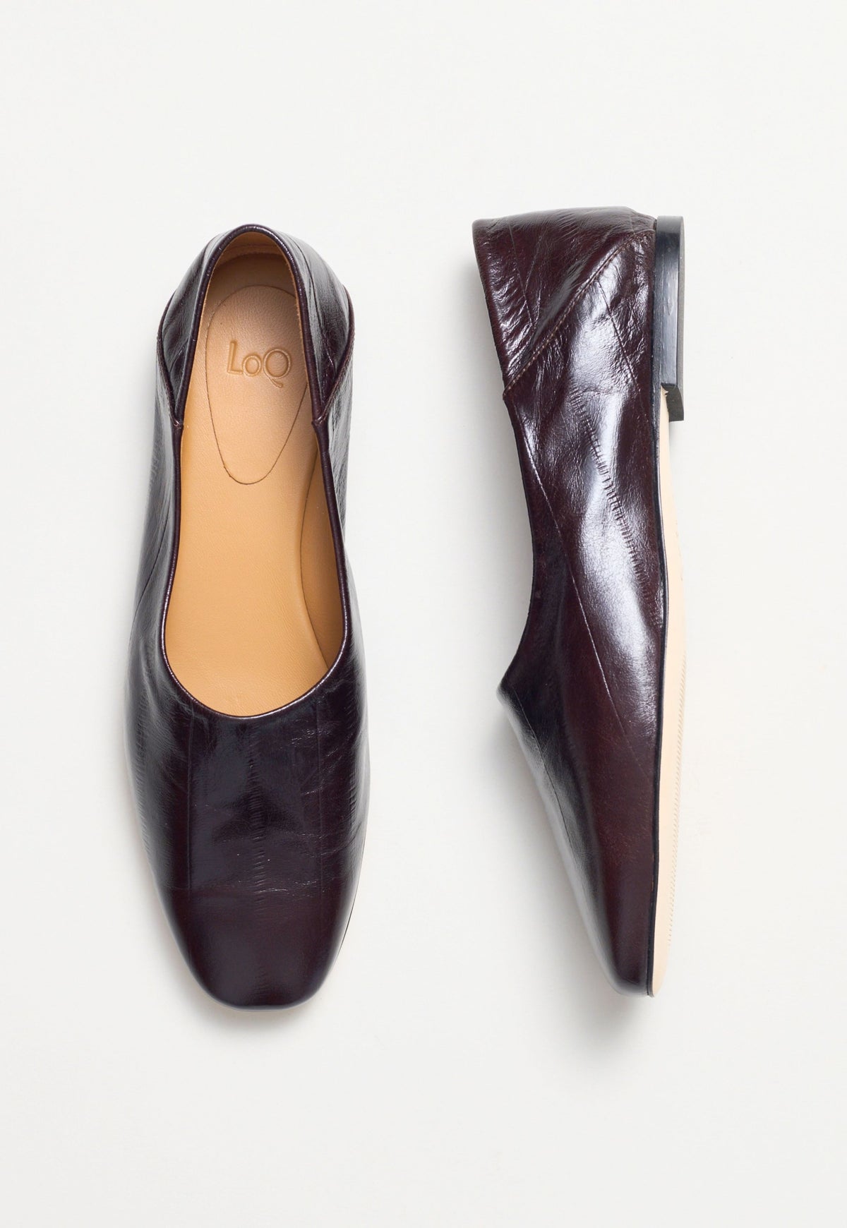 A pair of dark red leather ballet flats shown from the top and side views on a clean white background.