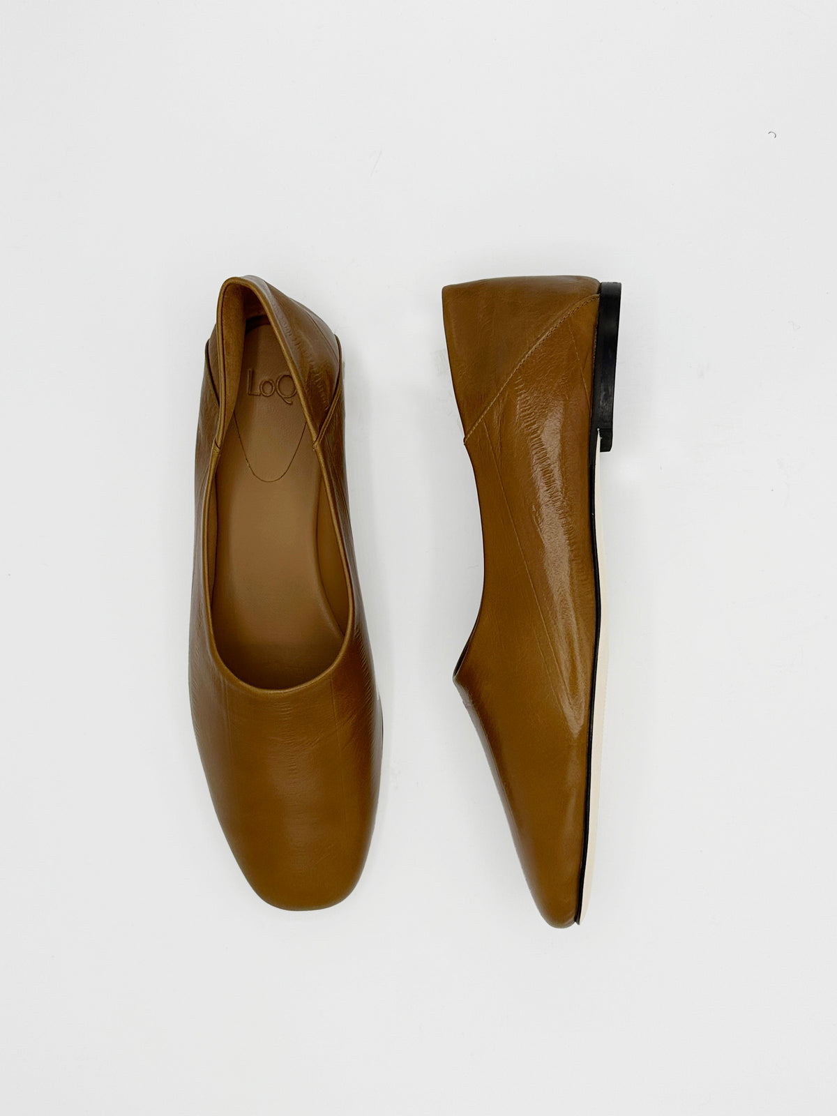 A pair of tan leather ballet flats shown from two angles (top-down and side-profile) on a clean white background.