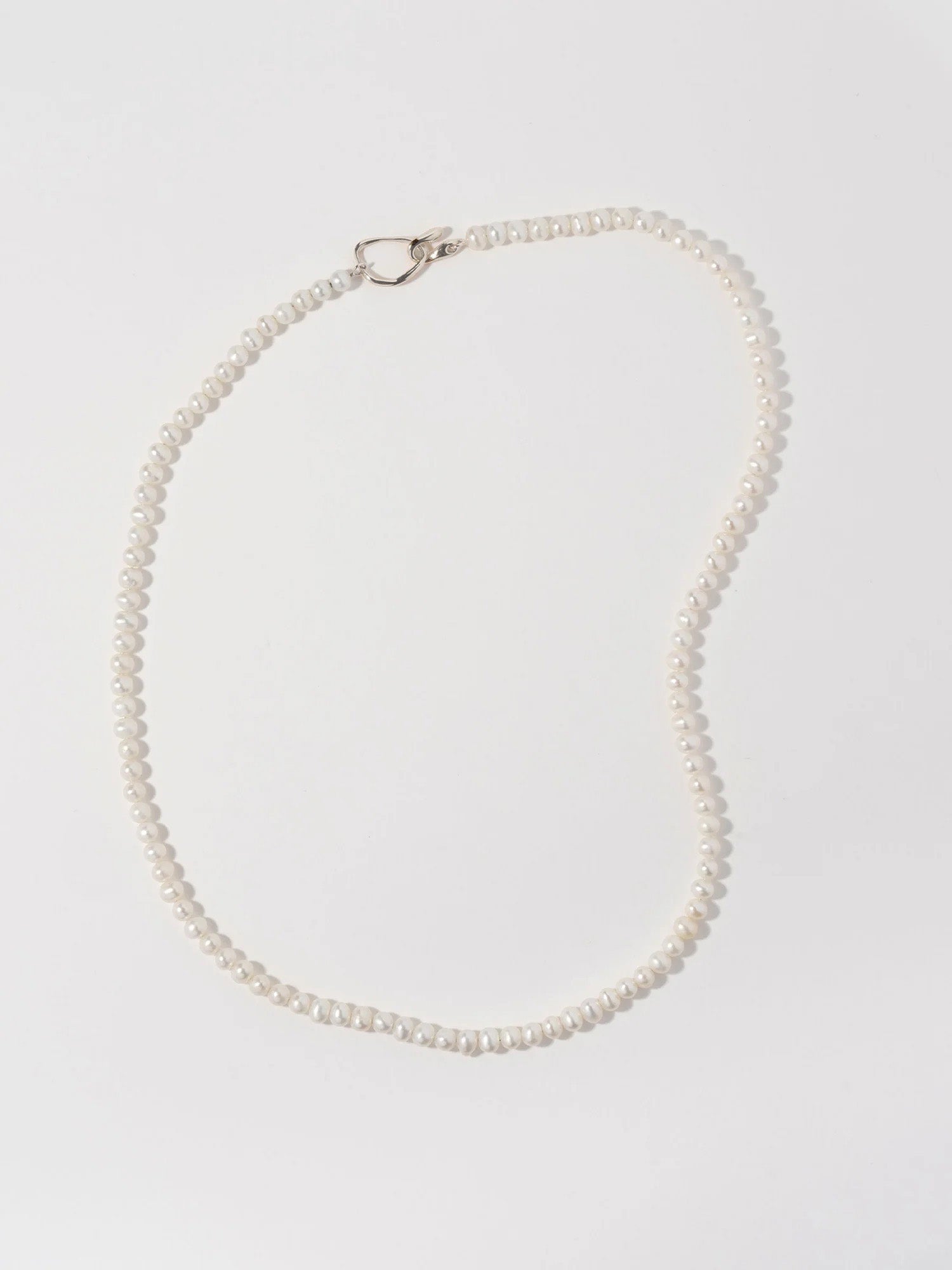 Delicate pearl choker length necklace with sterling silver closure.