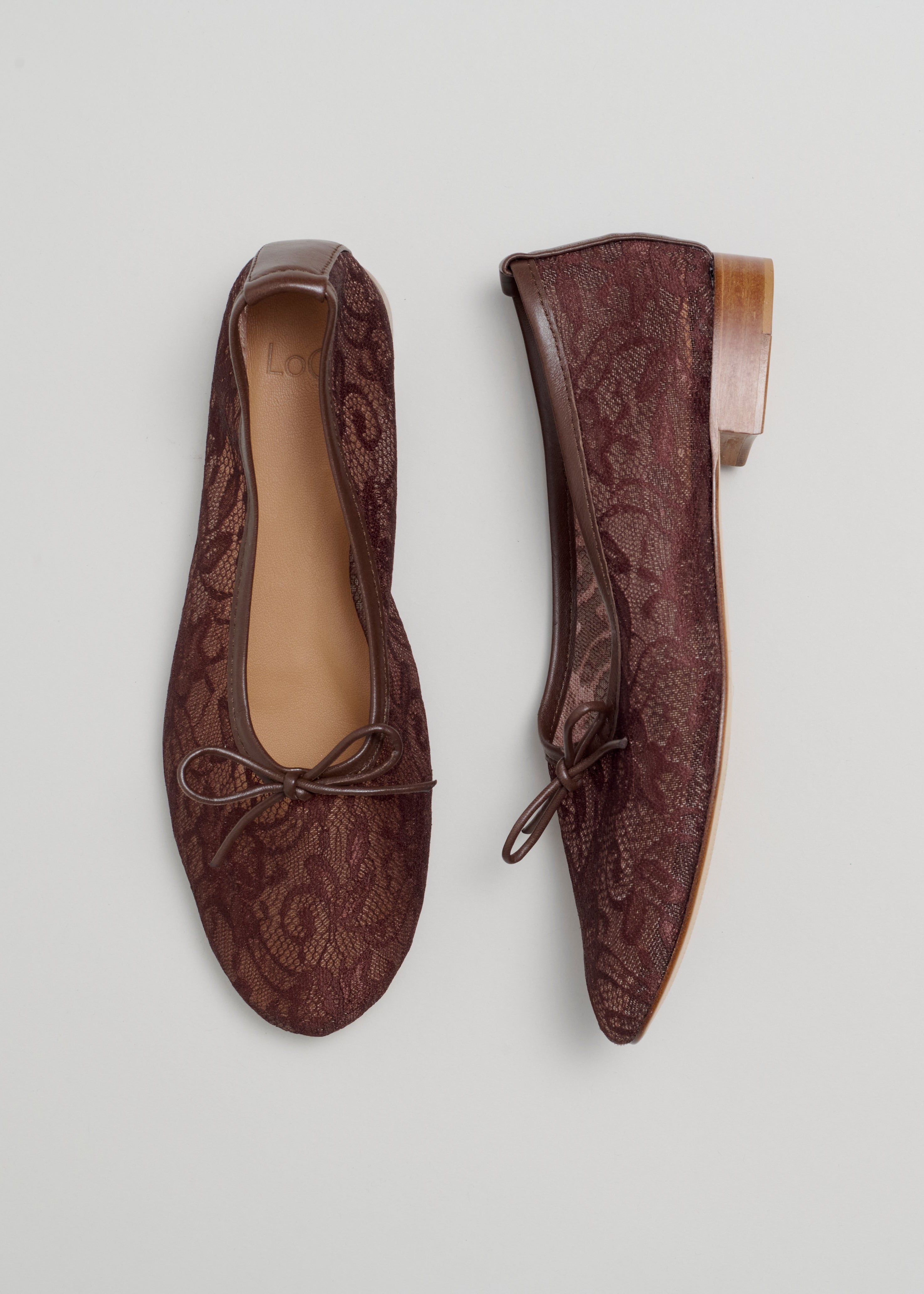 Pair of brown lace shoes on a light gray background