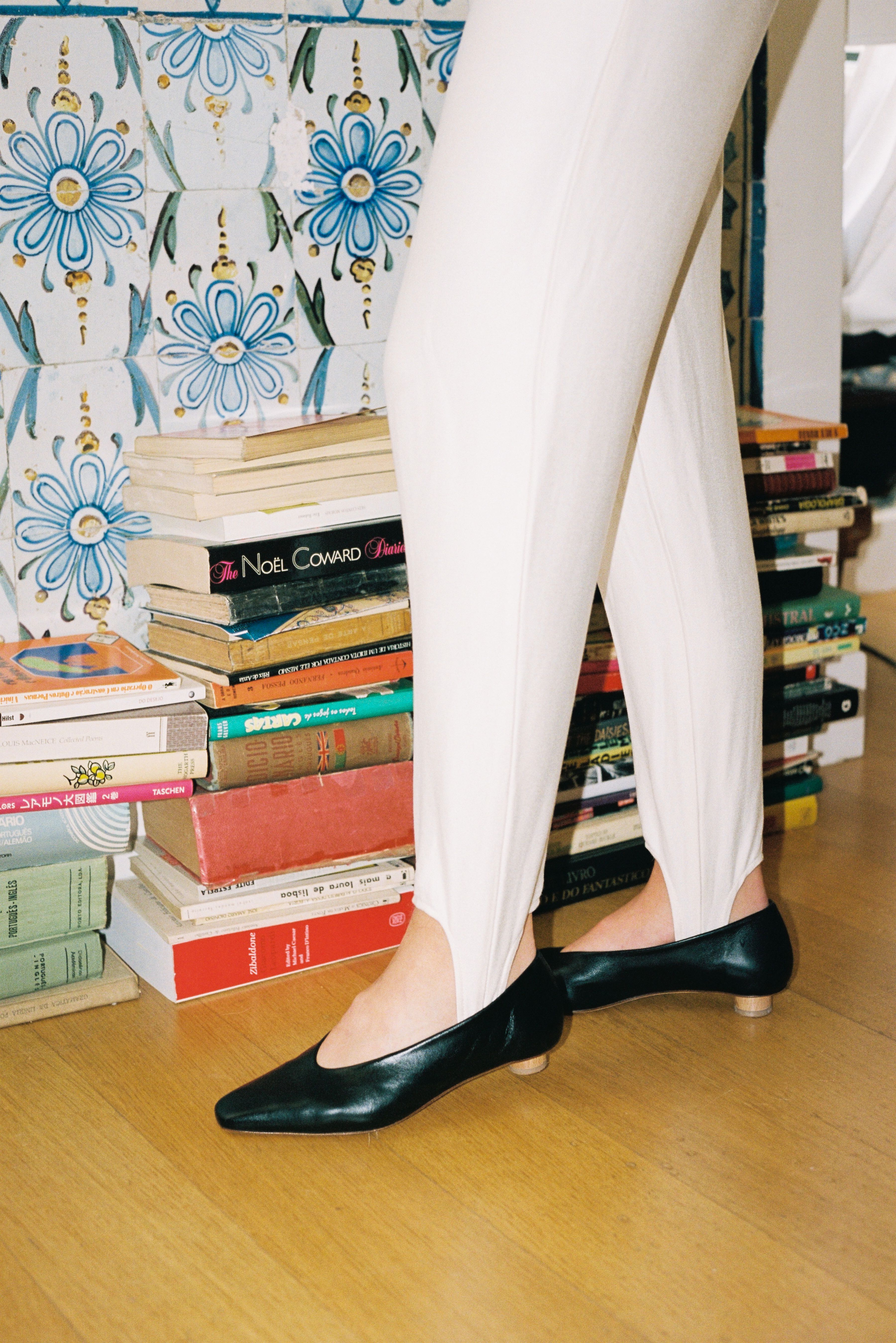 Ballet flat with a squared-off almond toe in smooth black leather. Glove-like fit. Mini ¾" cylinder beechwood heel.
