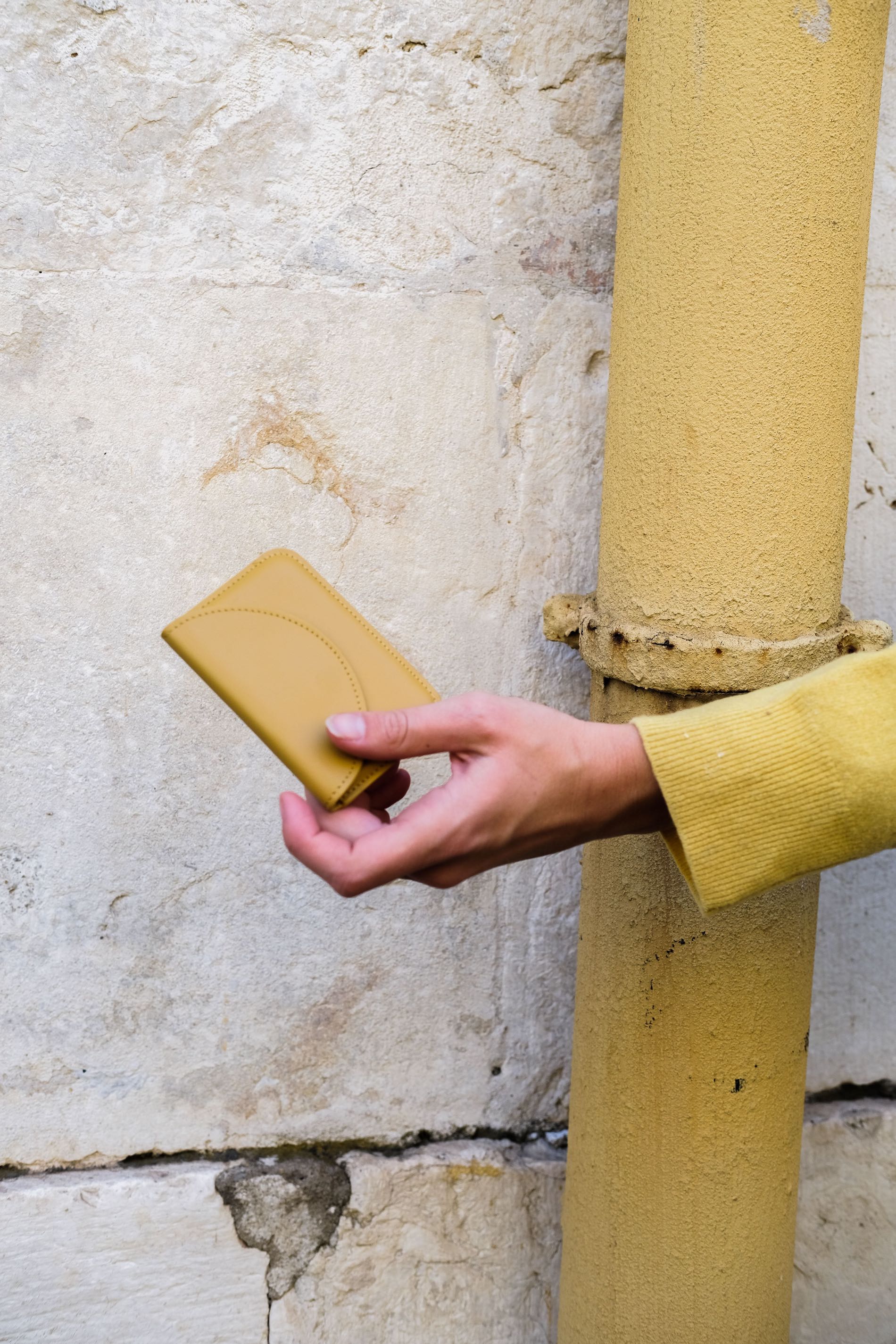 Yellow, card-sized wallet with envelope-style semicircle flap.