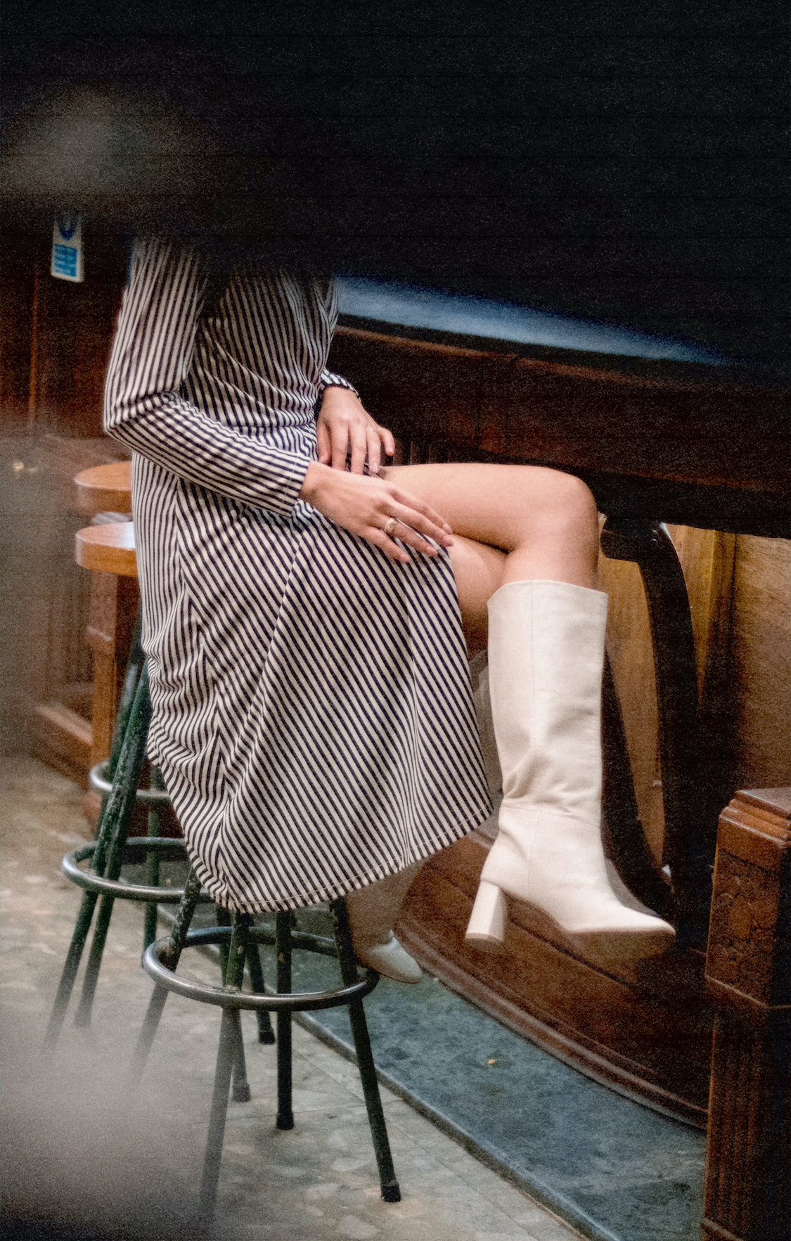 Tall pull-on boot in a supple cream, off-white leather that sits below the knee with a round toe