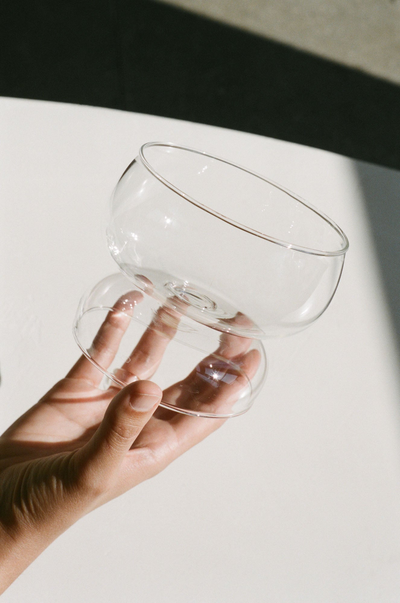 Wide rim cocktail glass with a sculptural statement stem in translucent glass.