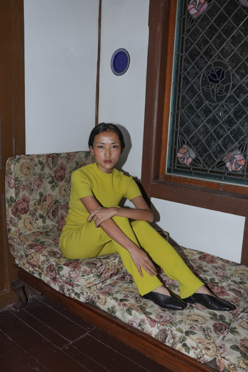 Model wears black leather flats with a tulip shaped upper.
