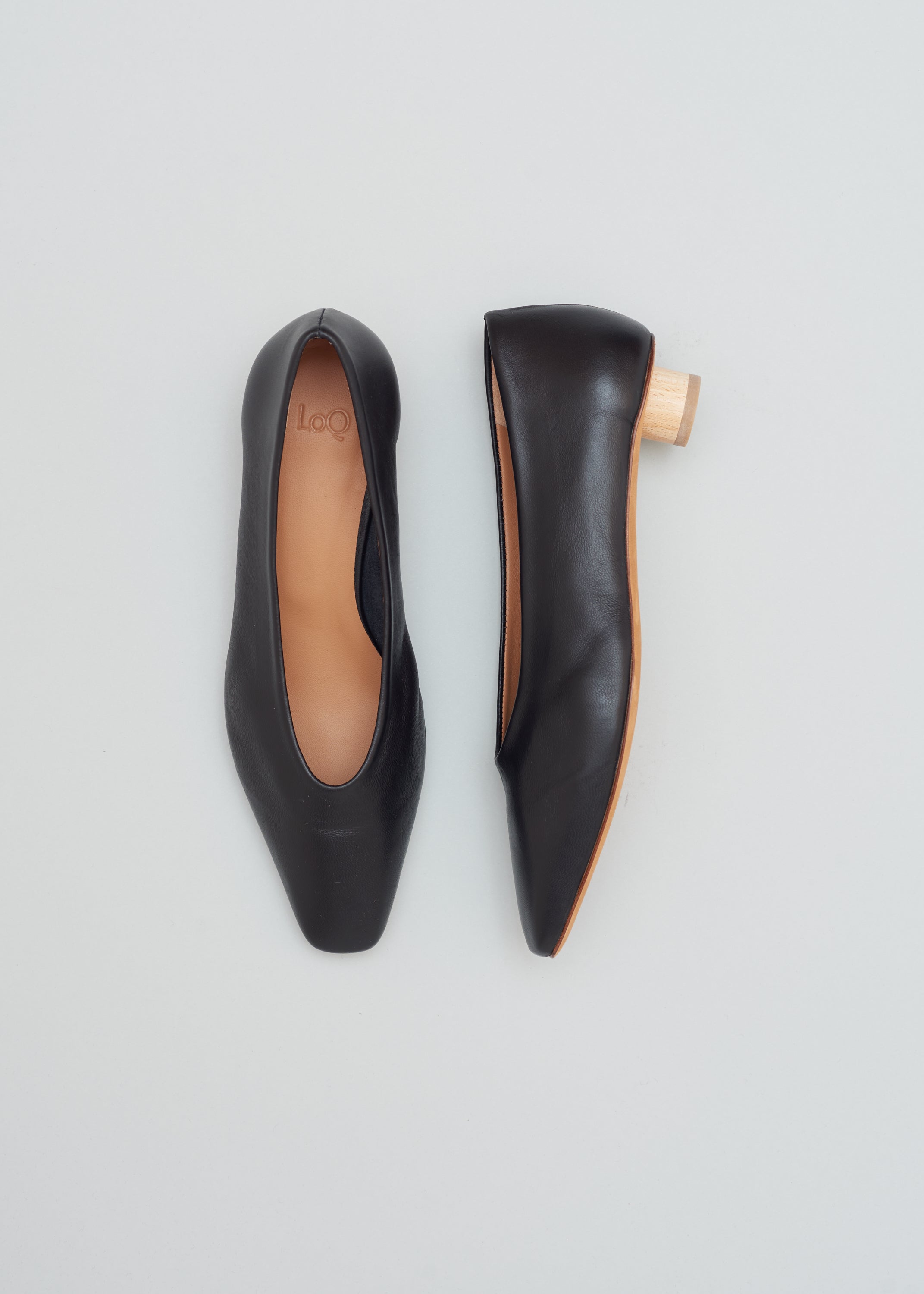 Ballet flat with a squared-off almond toe in smooth black leather. Glove-like fit. Mini ¾" cylinder beechwood heel.