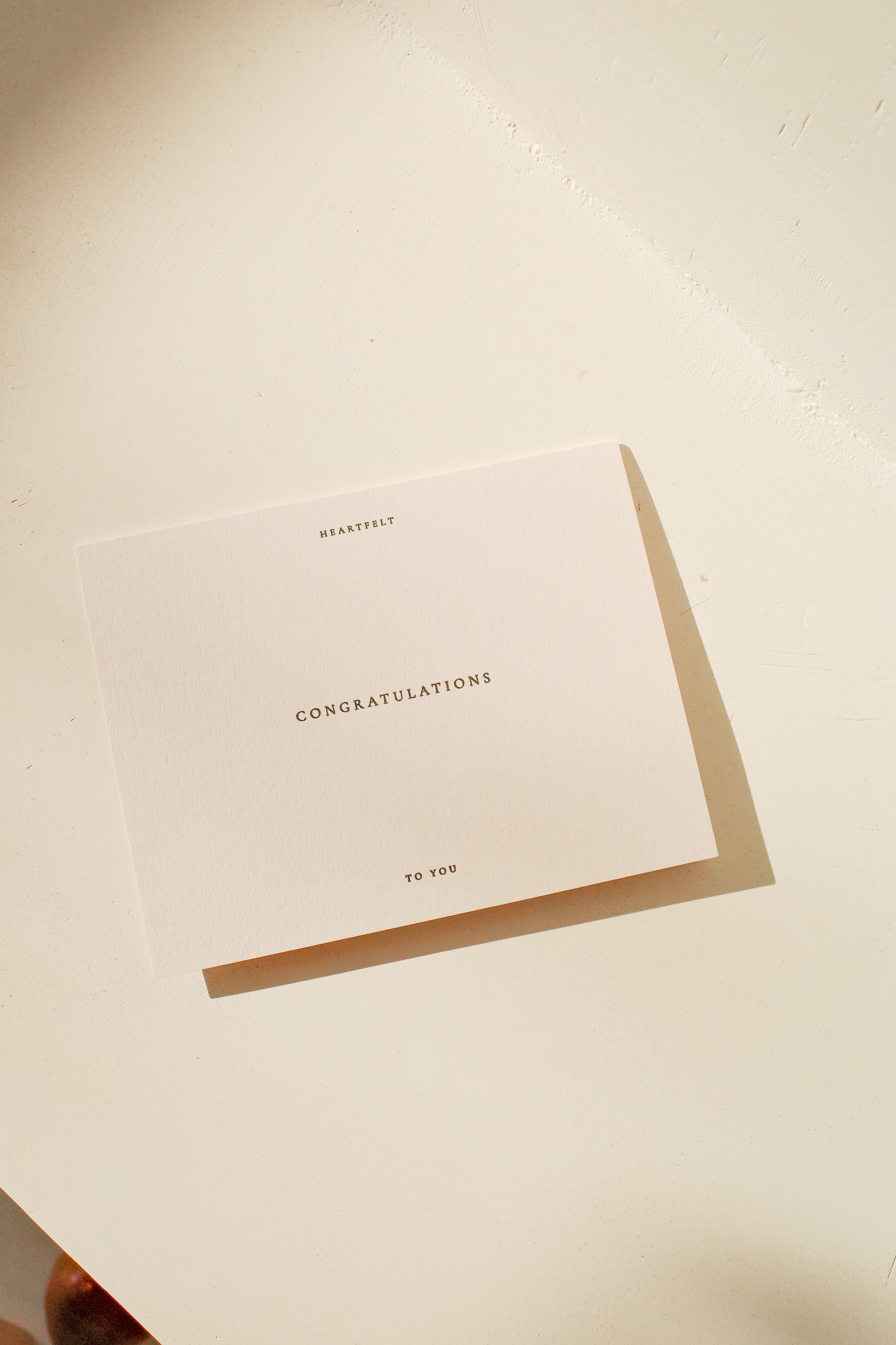 Off white congratulations card that reads: Heartfelt congratulations to you.