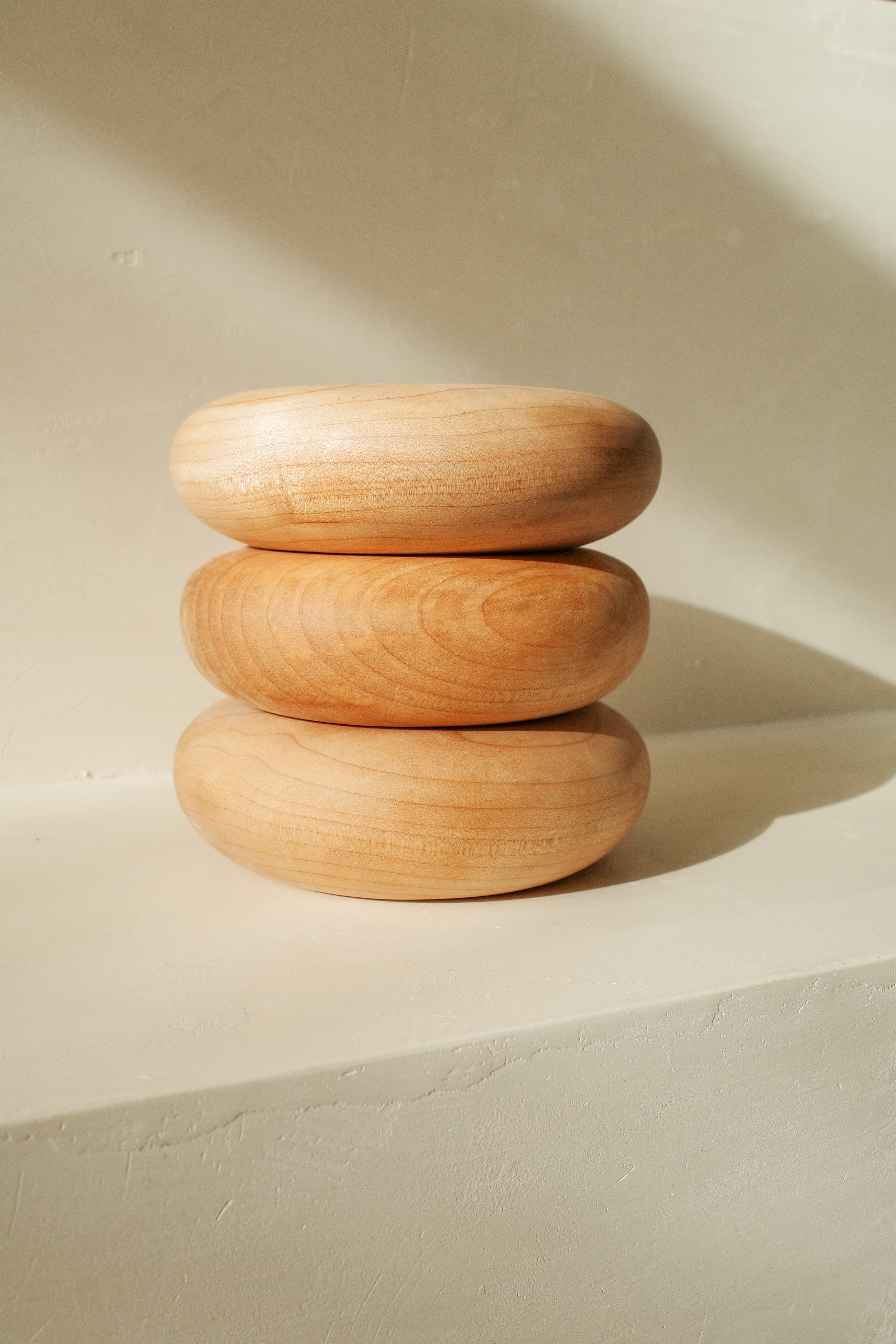 Sculptural donut shaped objects, hand turned with local maple wood.