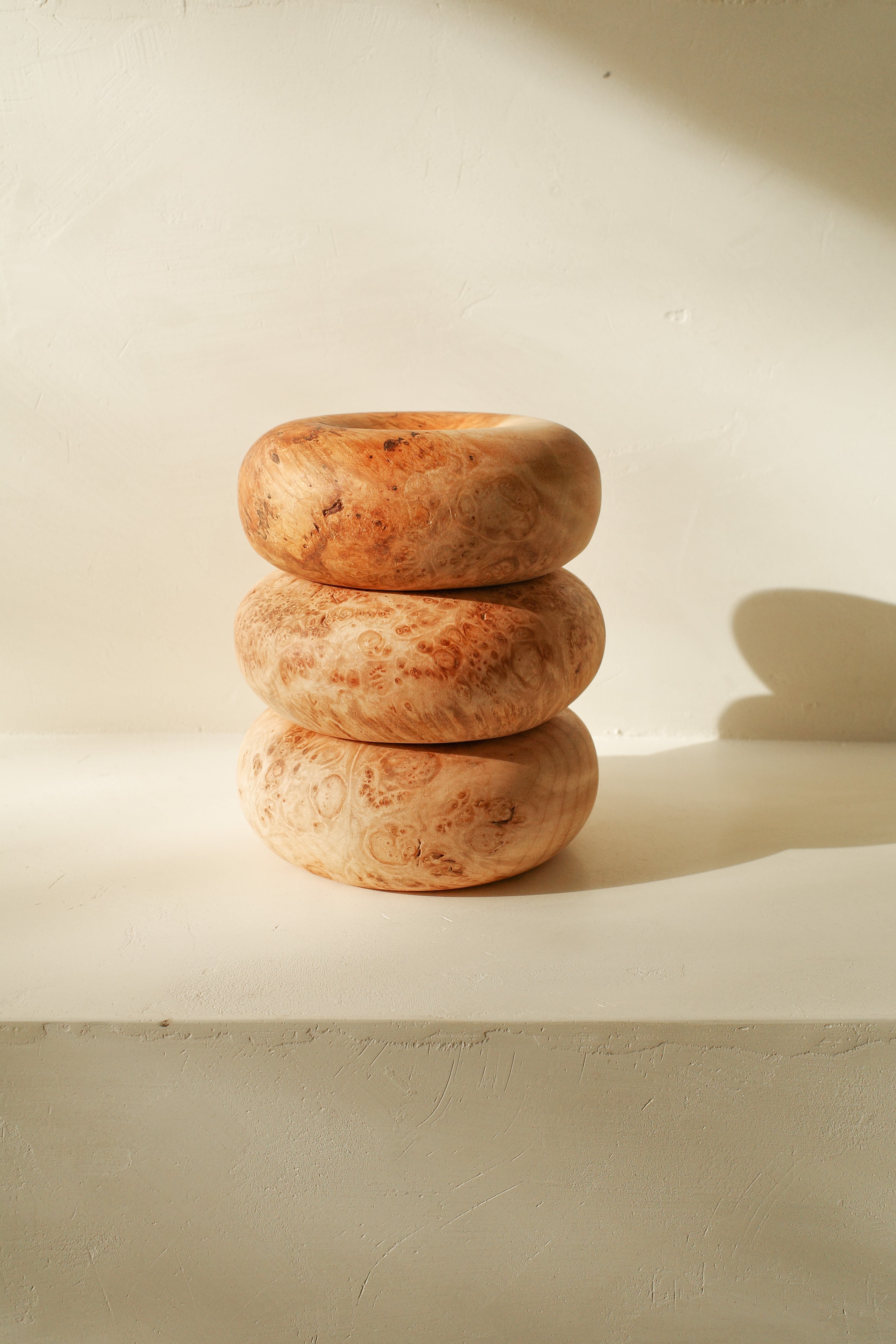 Sculptural donut shaped objects, hand turned with local maple wood.