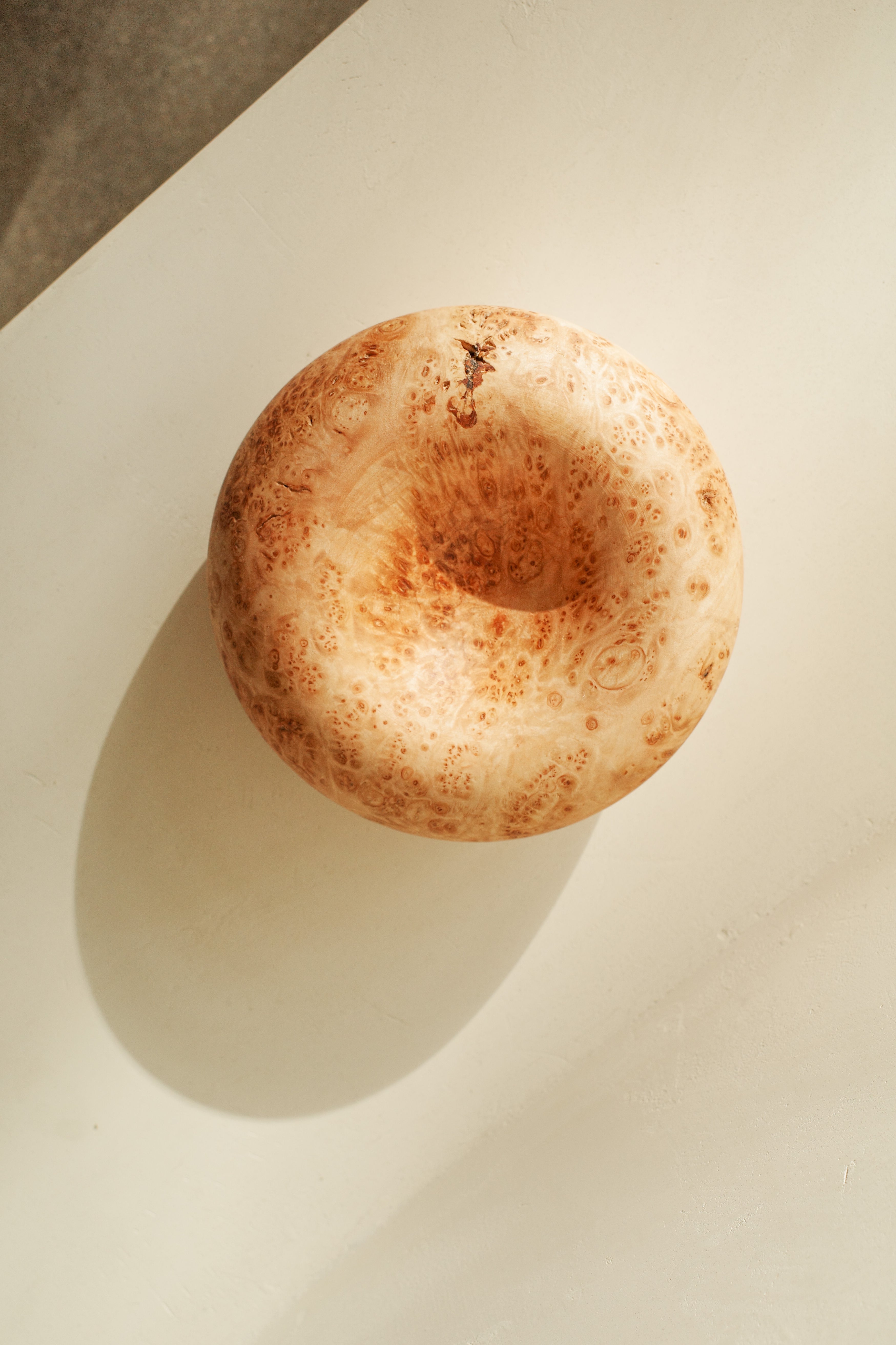 Sculptural donut shaped objects, hand turned with local maple wood.
