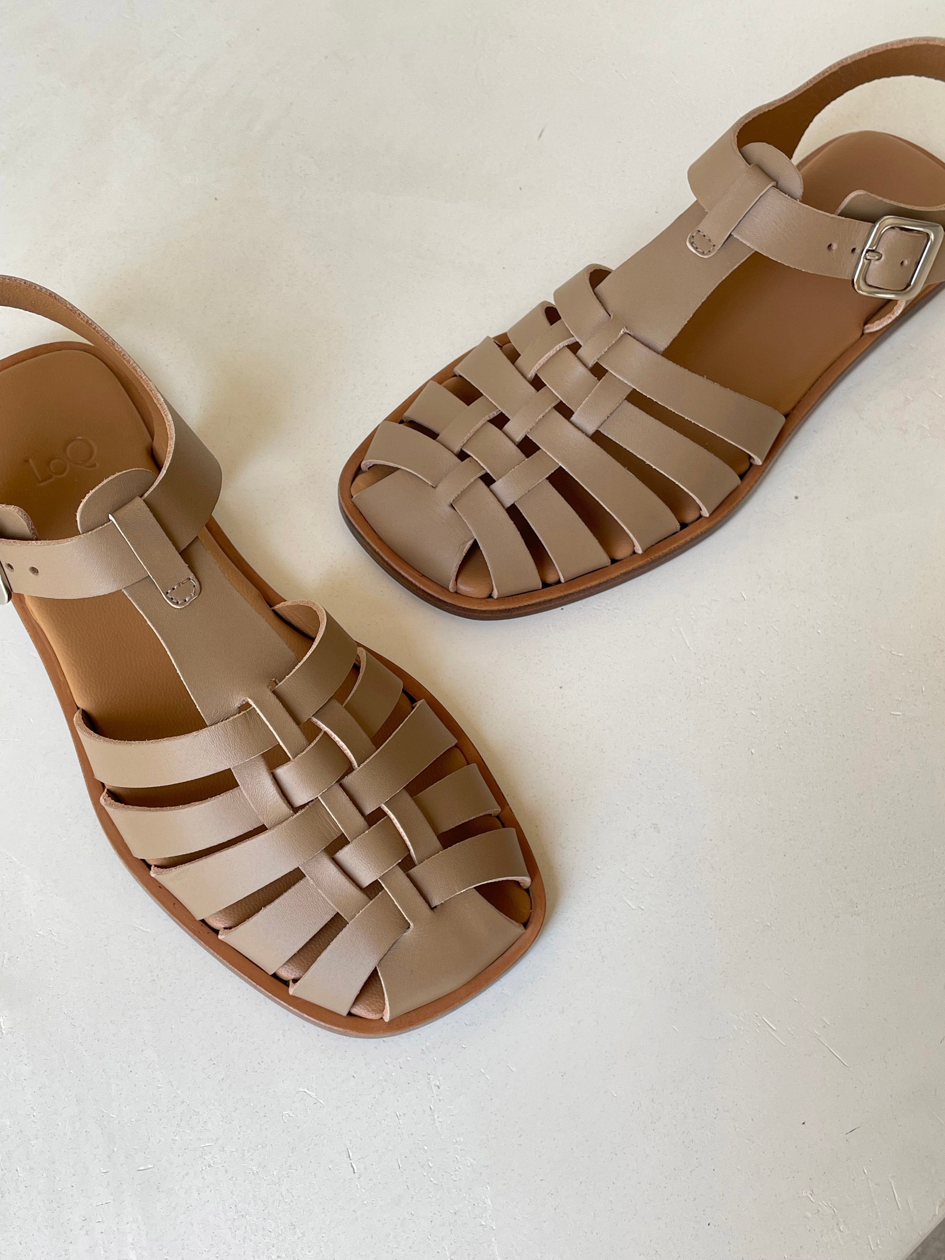 Fisherman sandal with a buckled closure and t-bar vamp in taupe leather. Vegetable-tanned leather upper and outsole.