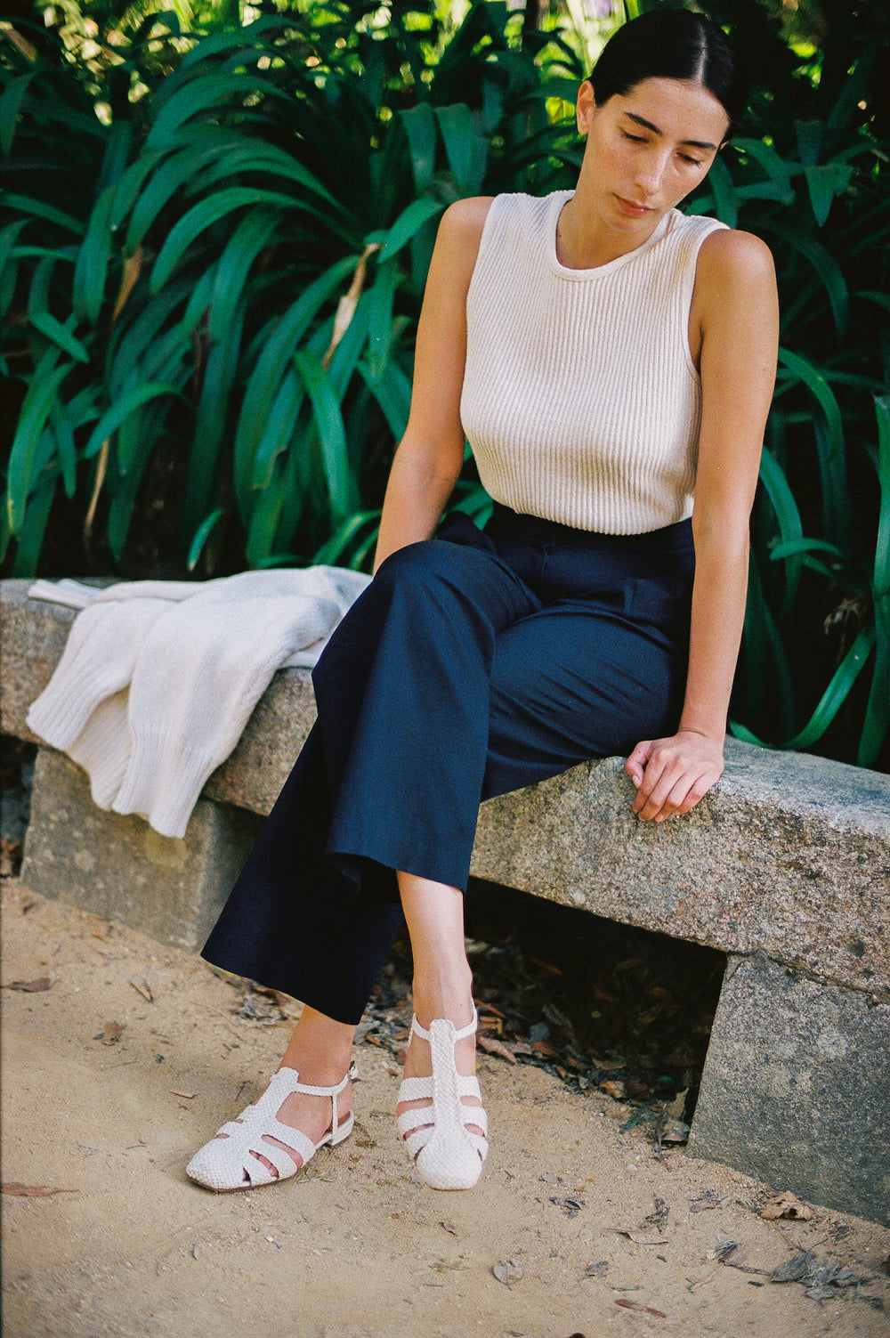 Fisherman-style sandals featuring straps made of woven leather across the foot and a strap that buckles around the ankle