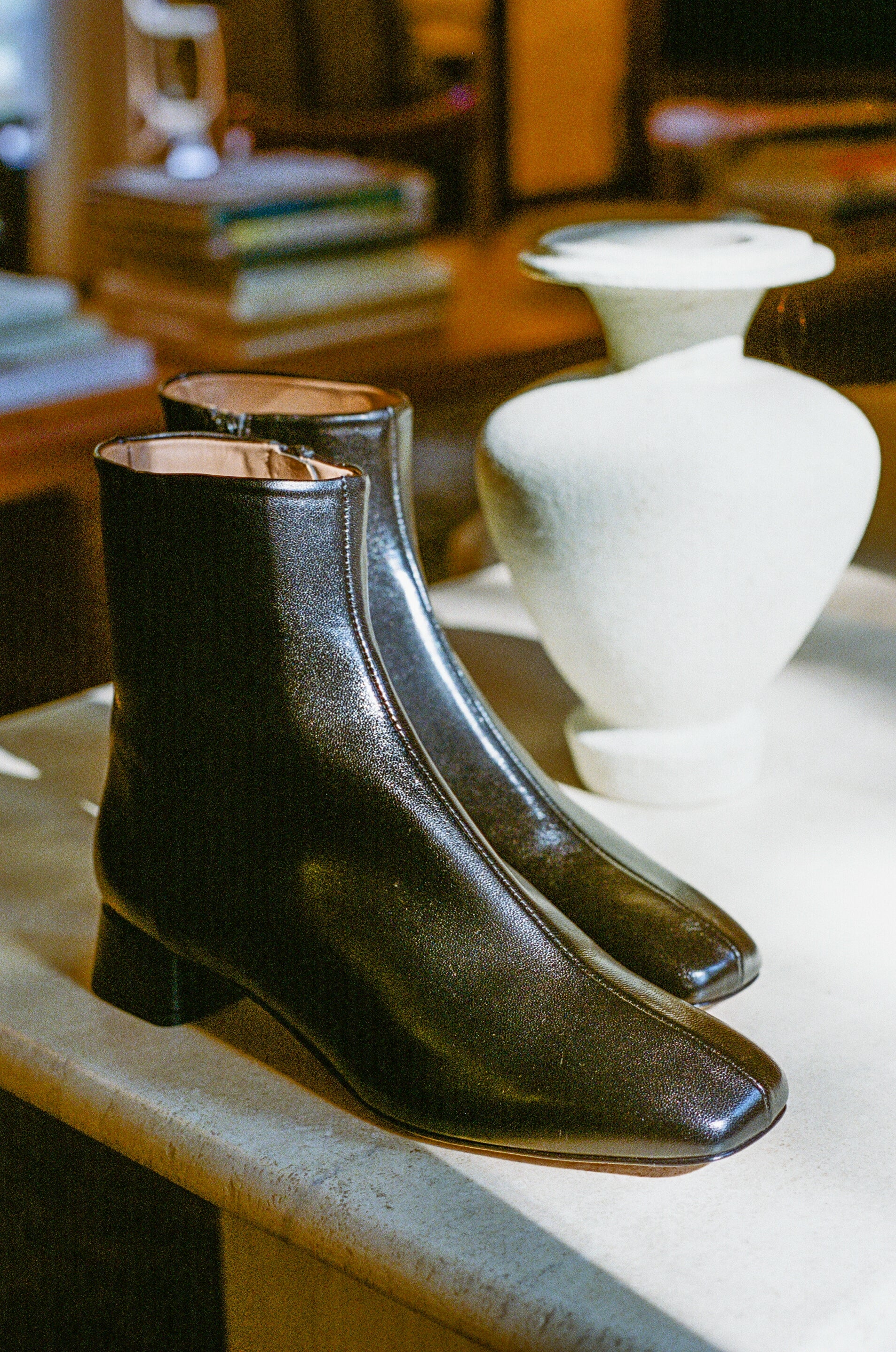 Black ankle boot with center seam and side zipper.
