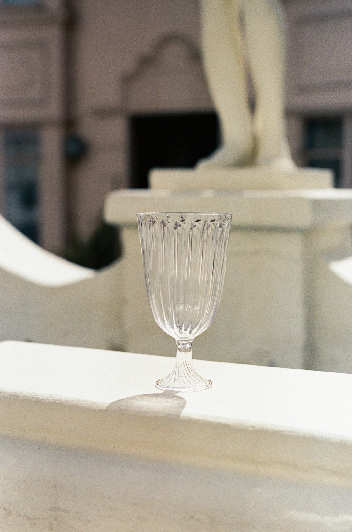 Empty ribbed wine glass.