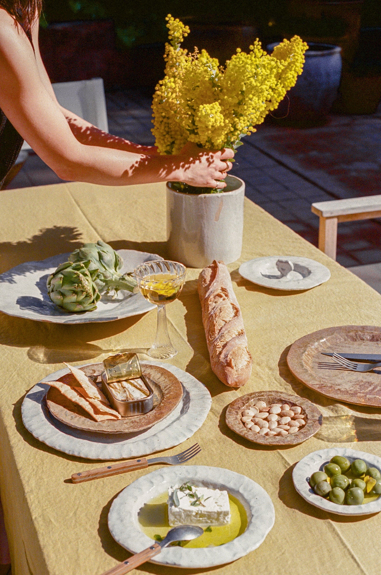 Tablescape with handmade ceramics in varying sizes and colors.