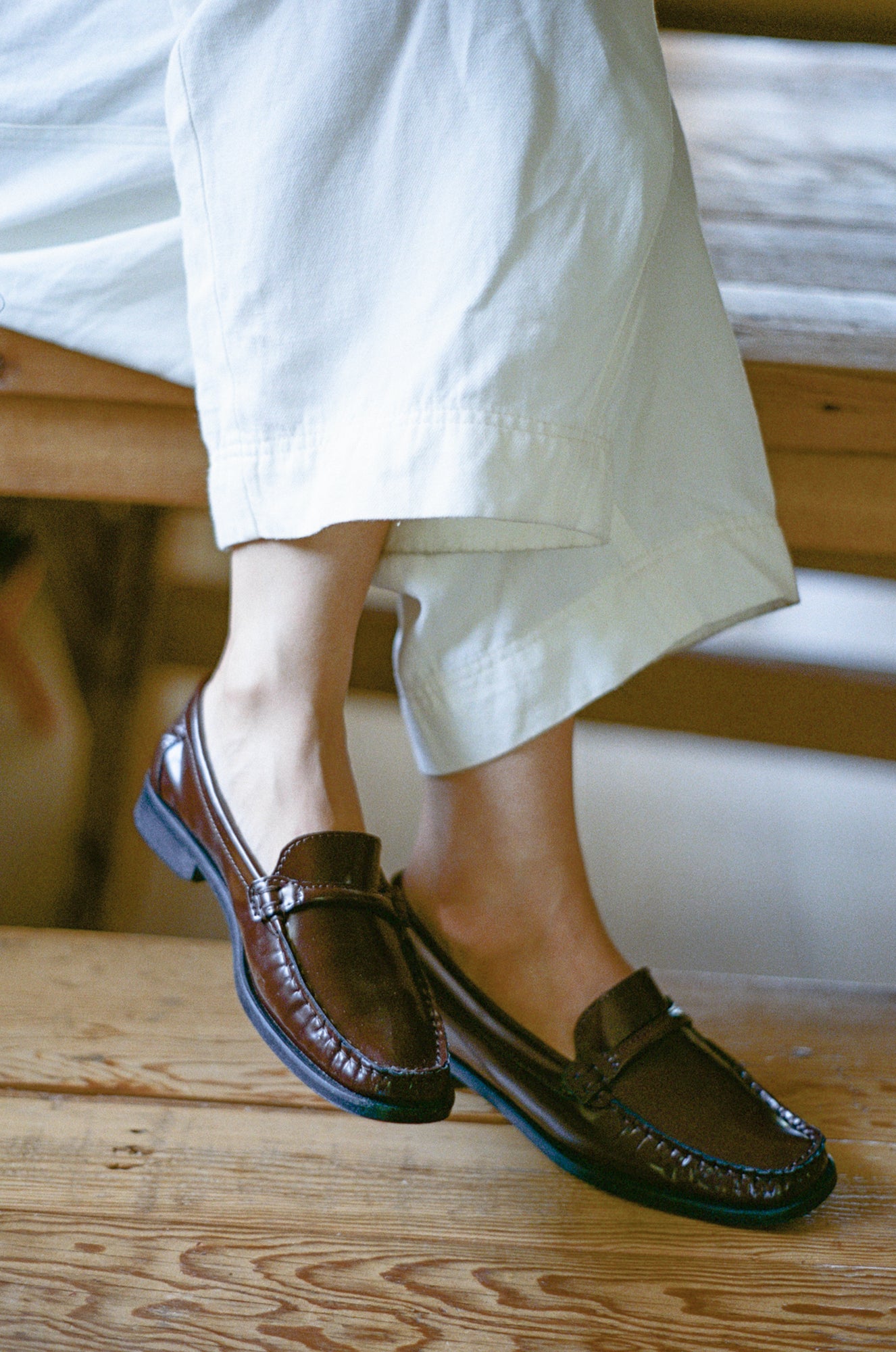 Model wears loafer in warm brown leather.