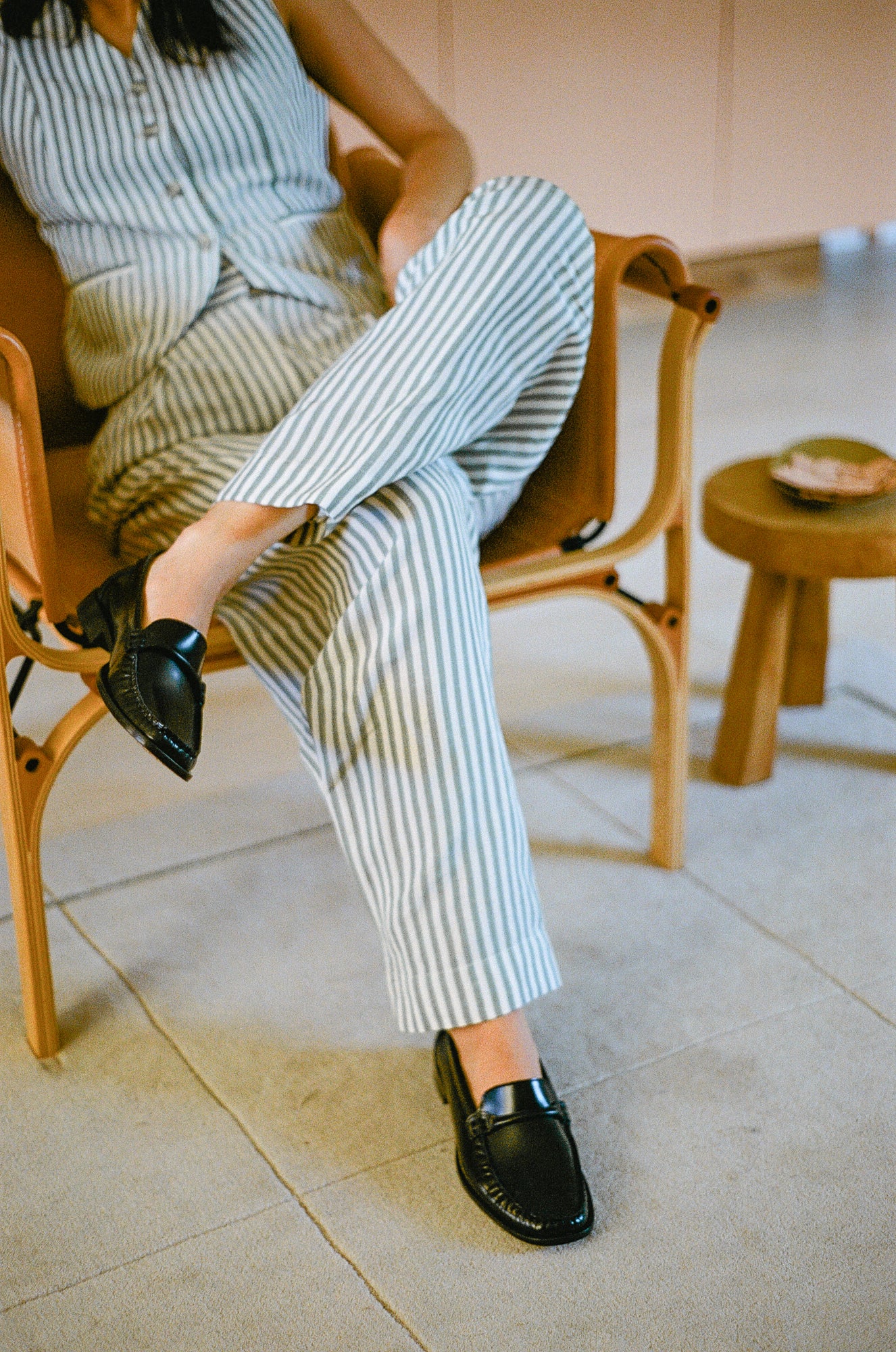 Model wears loafer in black smooth leather.