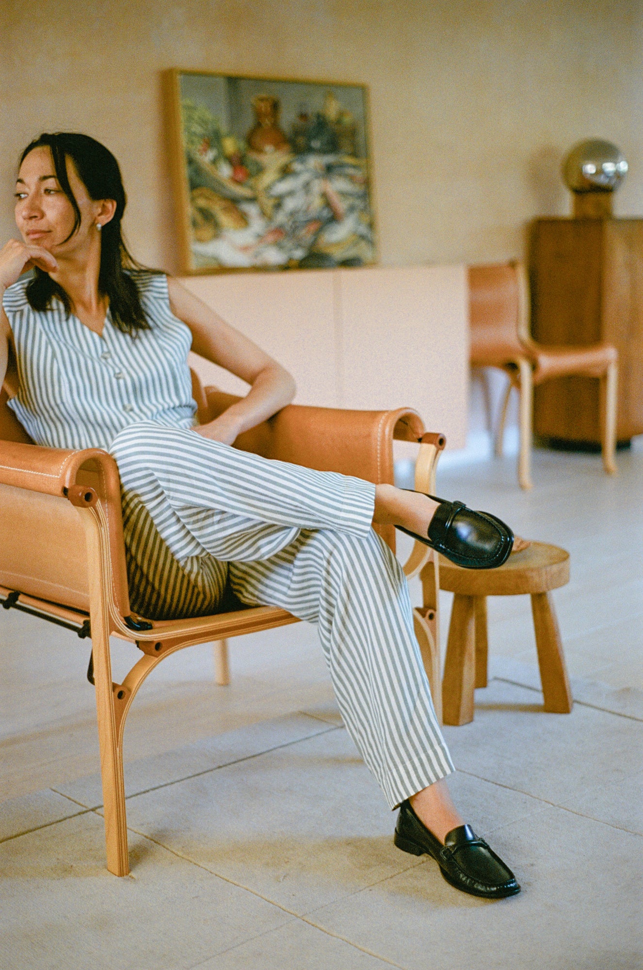Model wears loafer in black smooth leather.