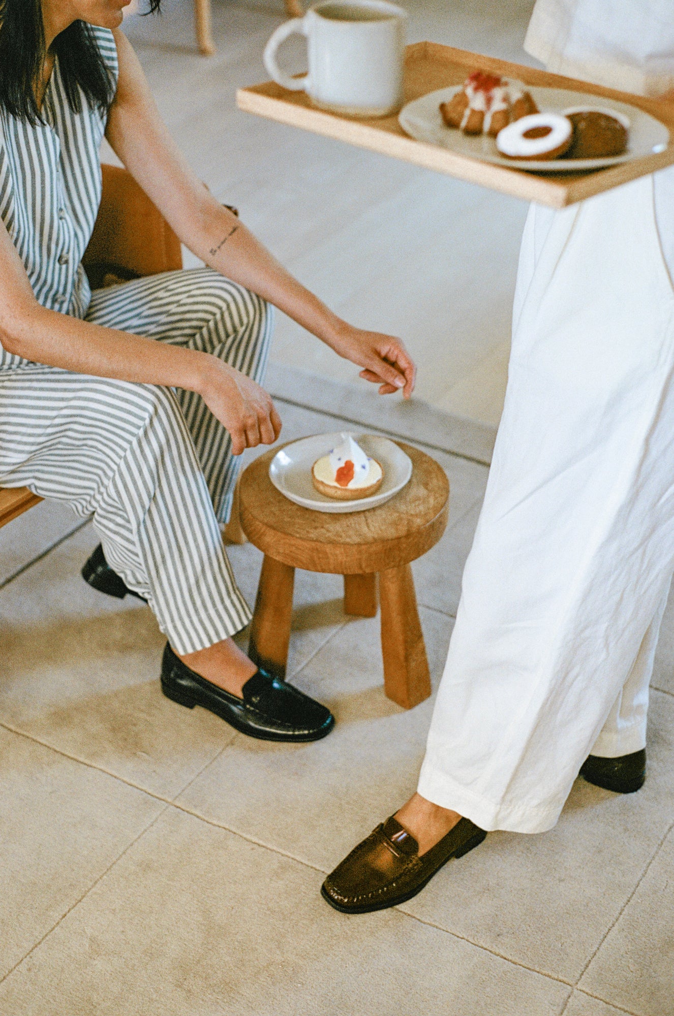 Models wearing loafers with snacks.