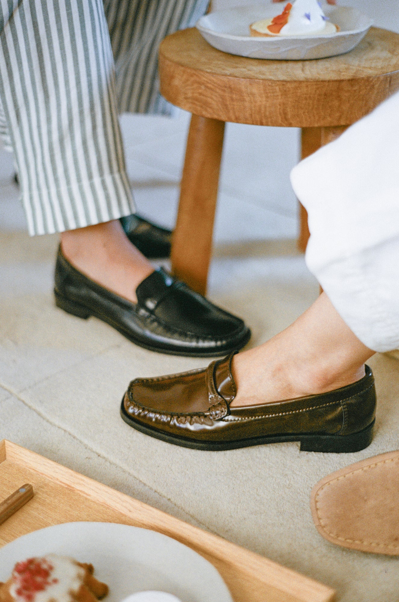 Model wears loafer in warm brown leather.