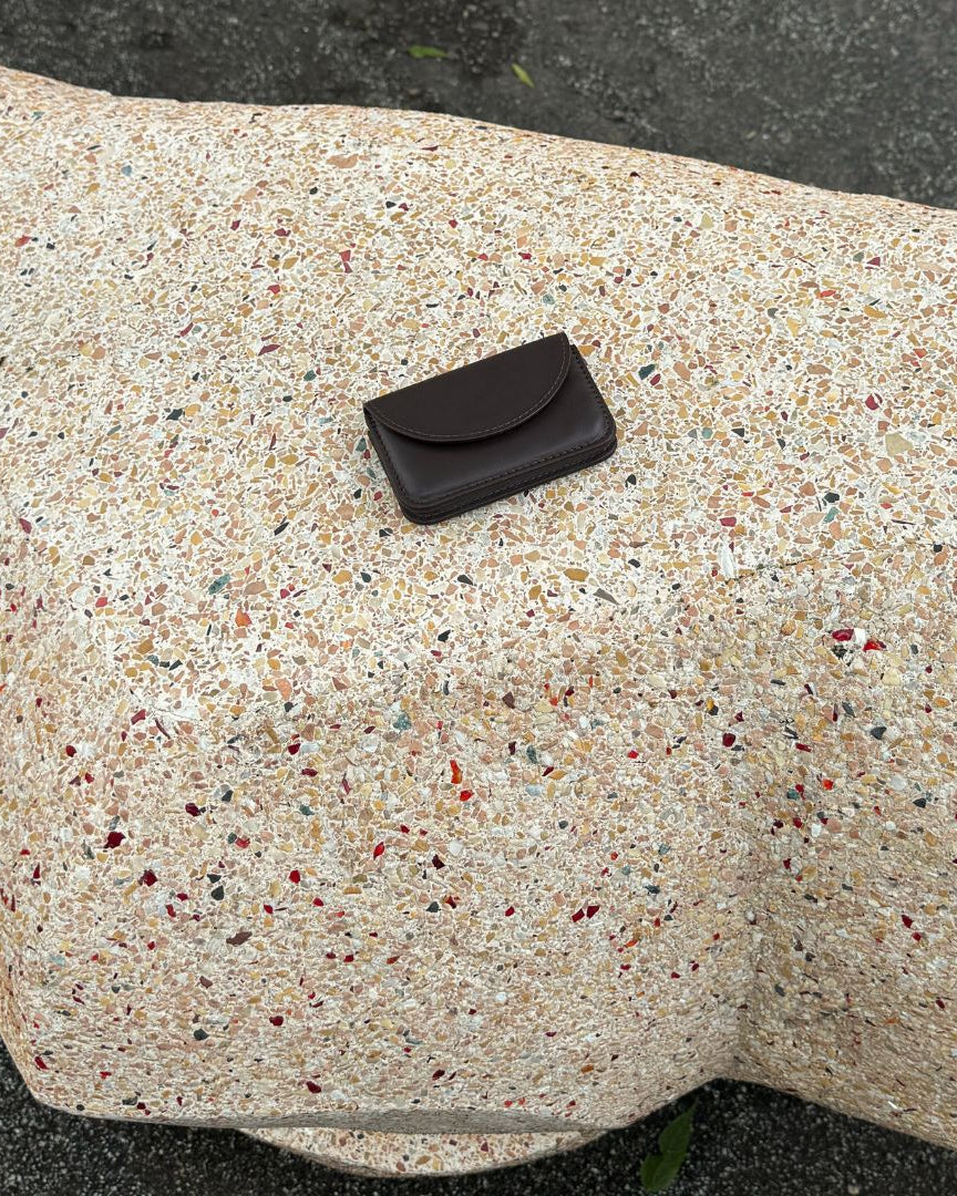 Brown wallet on a textured stone surface
