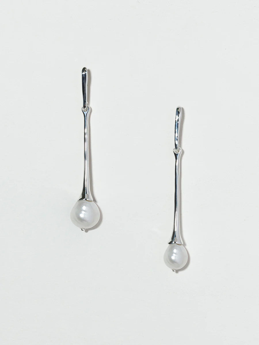 Long sterling silver drop earrings with large pearl at the bottom.