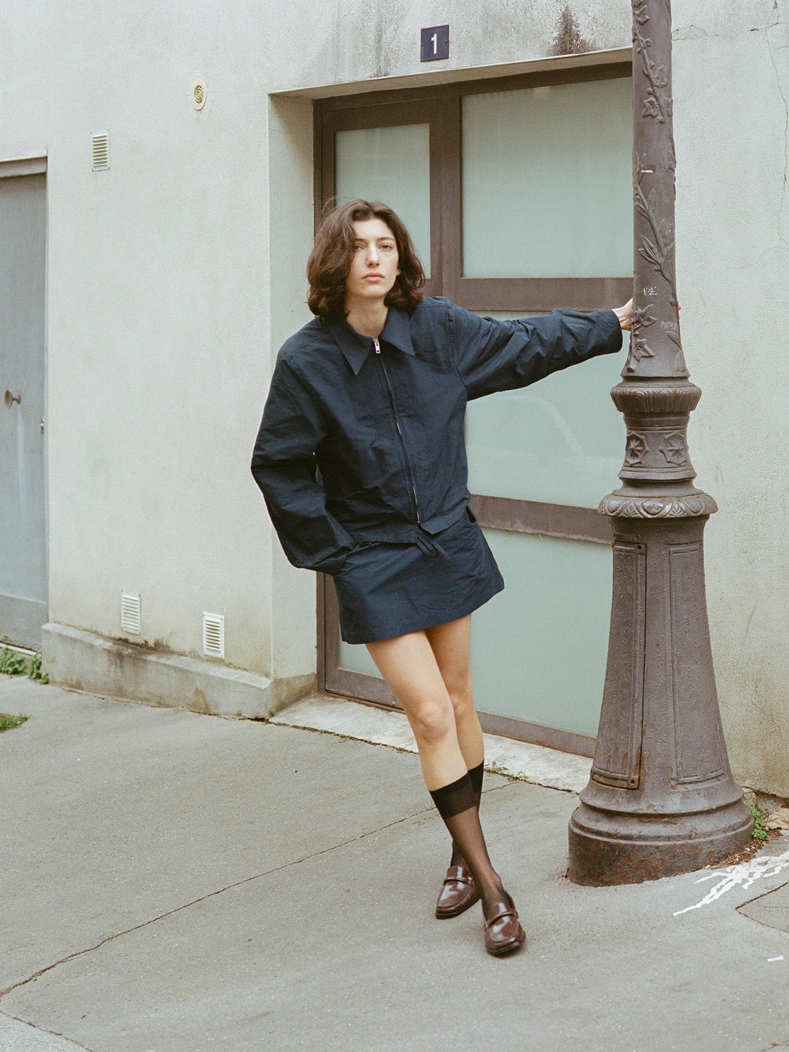 Model wears chocolate brown leather loafer.