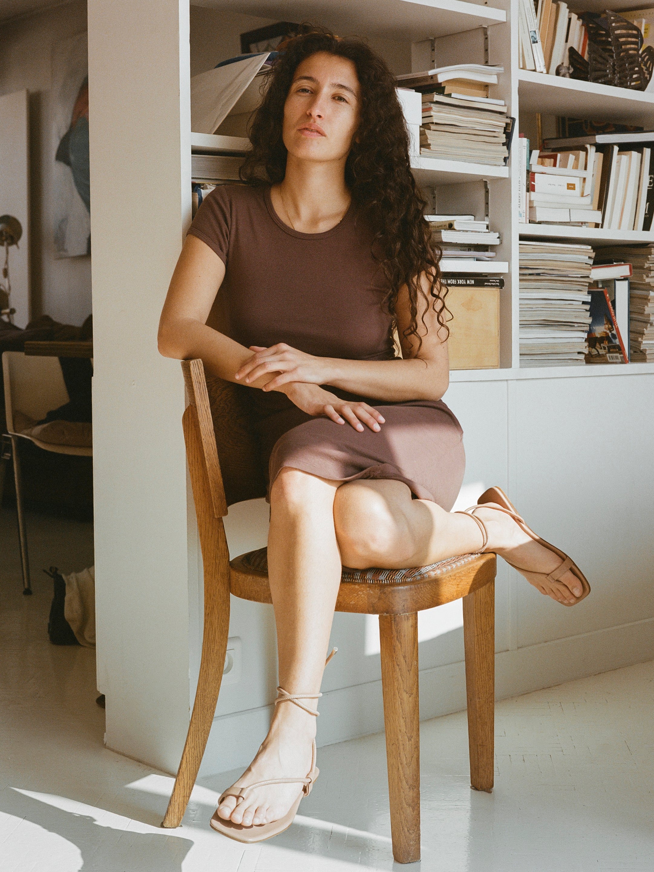 Model wears tan colored ankle wrap sandals.