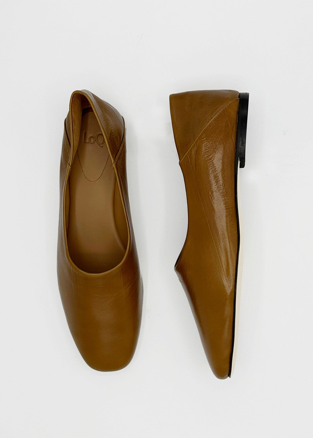 A pair of tan leather ballet flats shown from two angles (top-down and side-profile) on a clean white background.