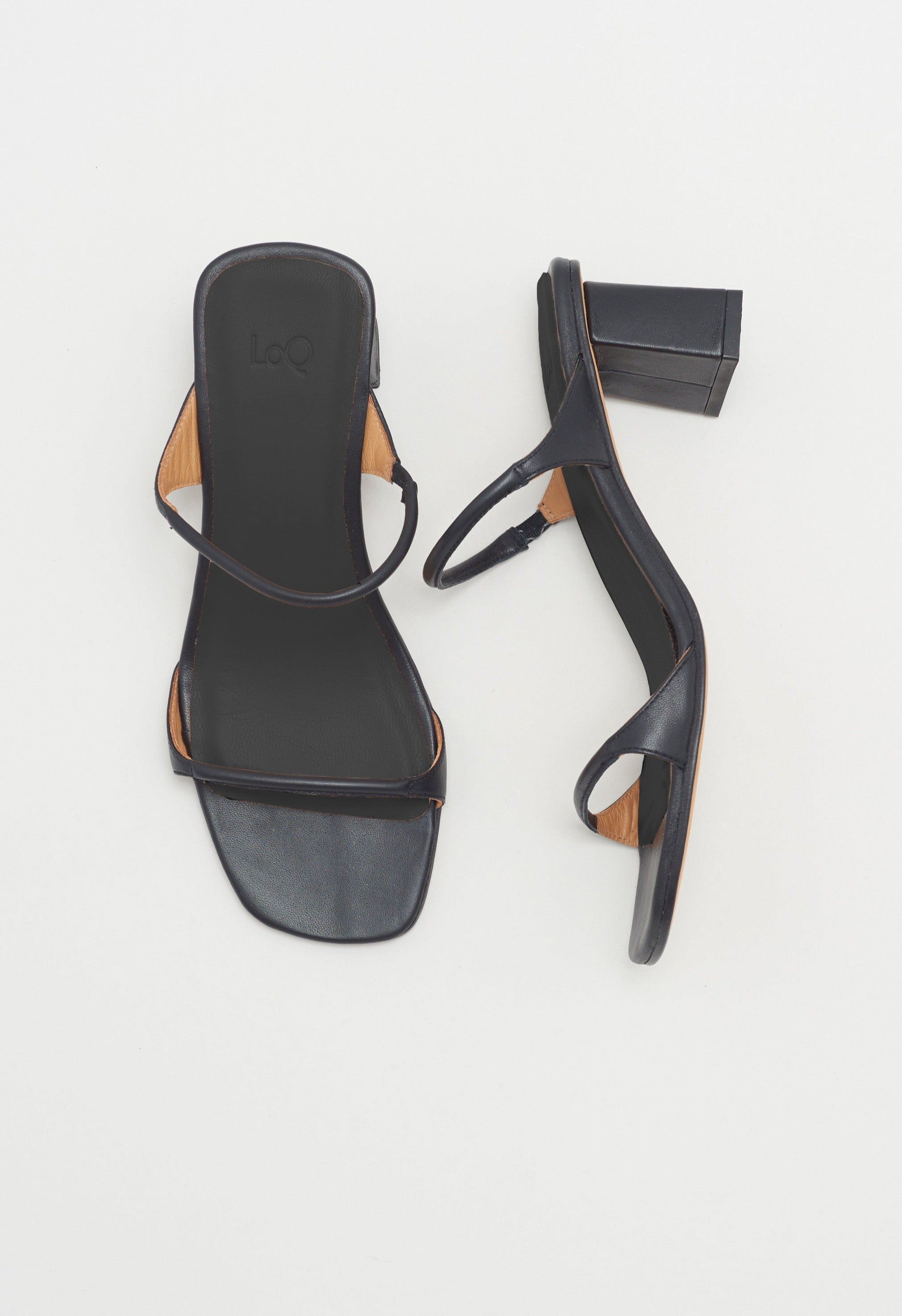 Black heeled leather sandal featuring two thin straps and square block heel.