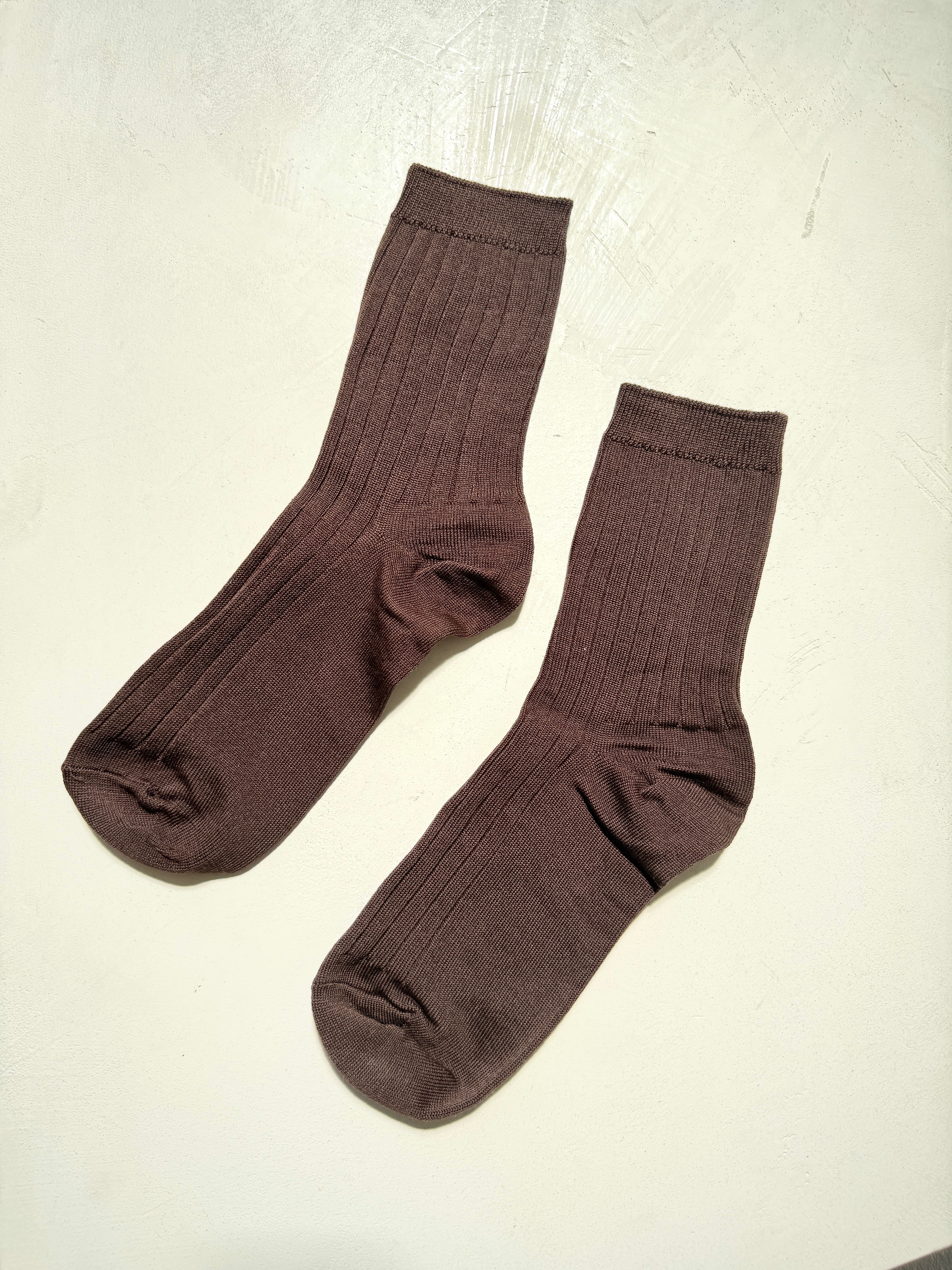 Pair of brown socks on a light gray background
