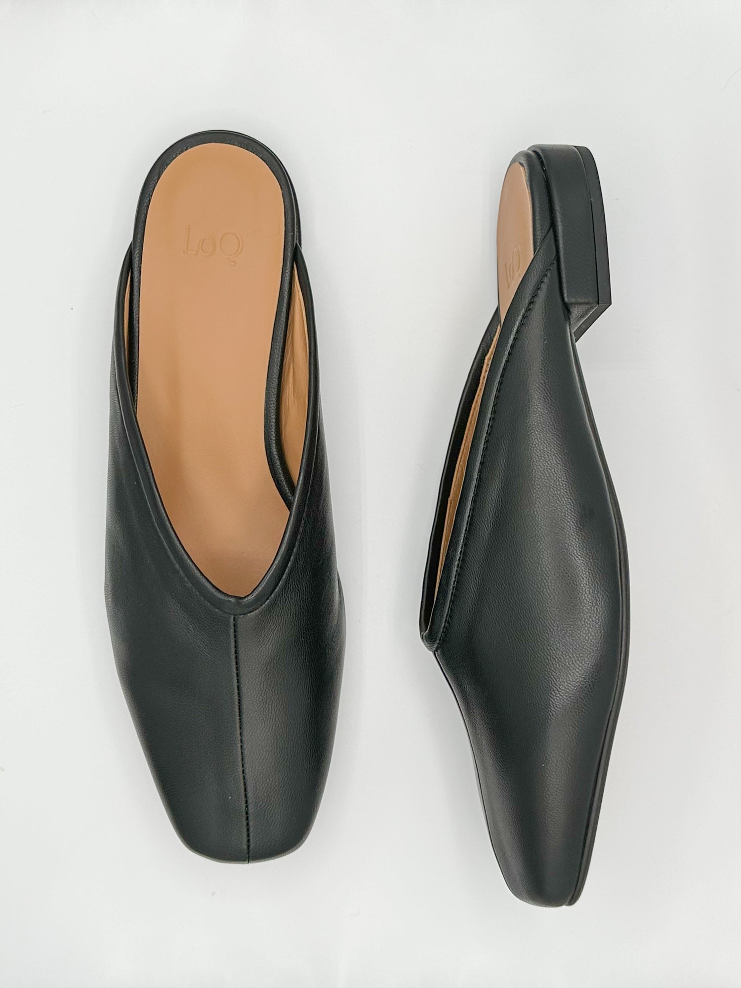 Flat black leather slides with v shaped upper and center seam.