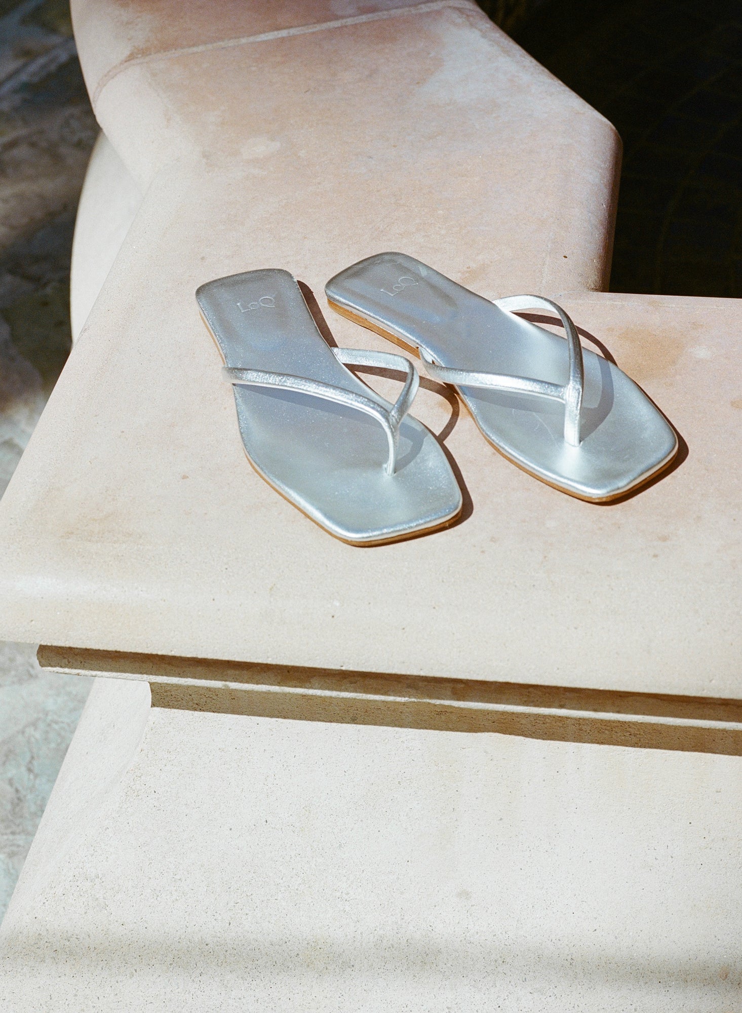 Minimal metallic silver leather flip flop style thong sandal.