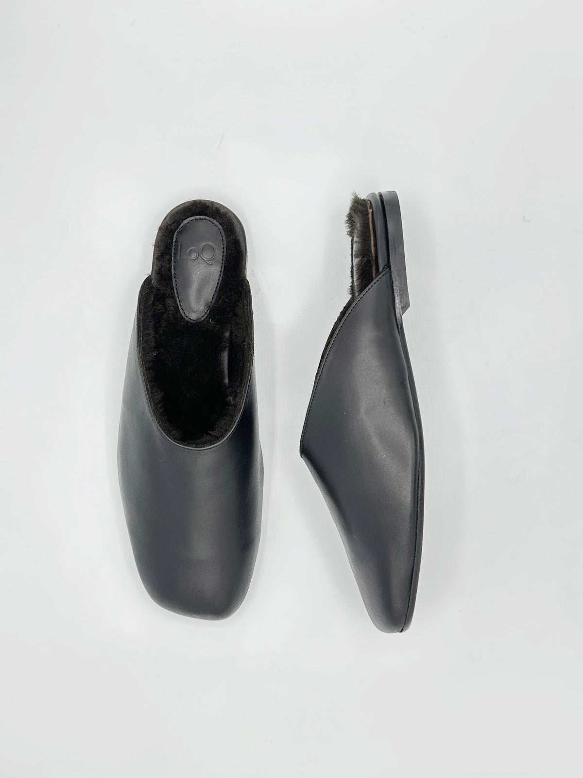 A pair of leather flat mules with matching fur lining