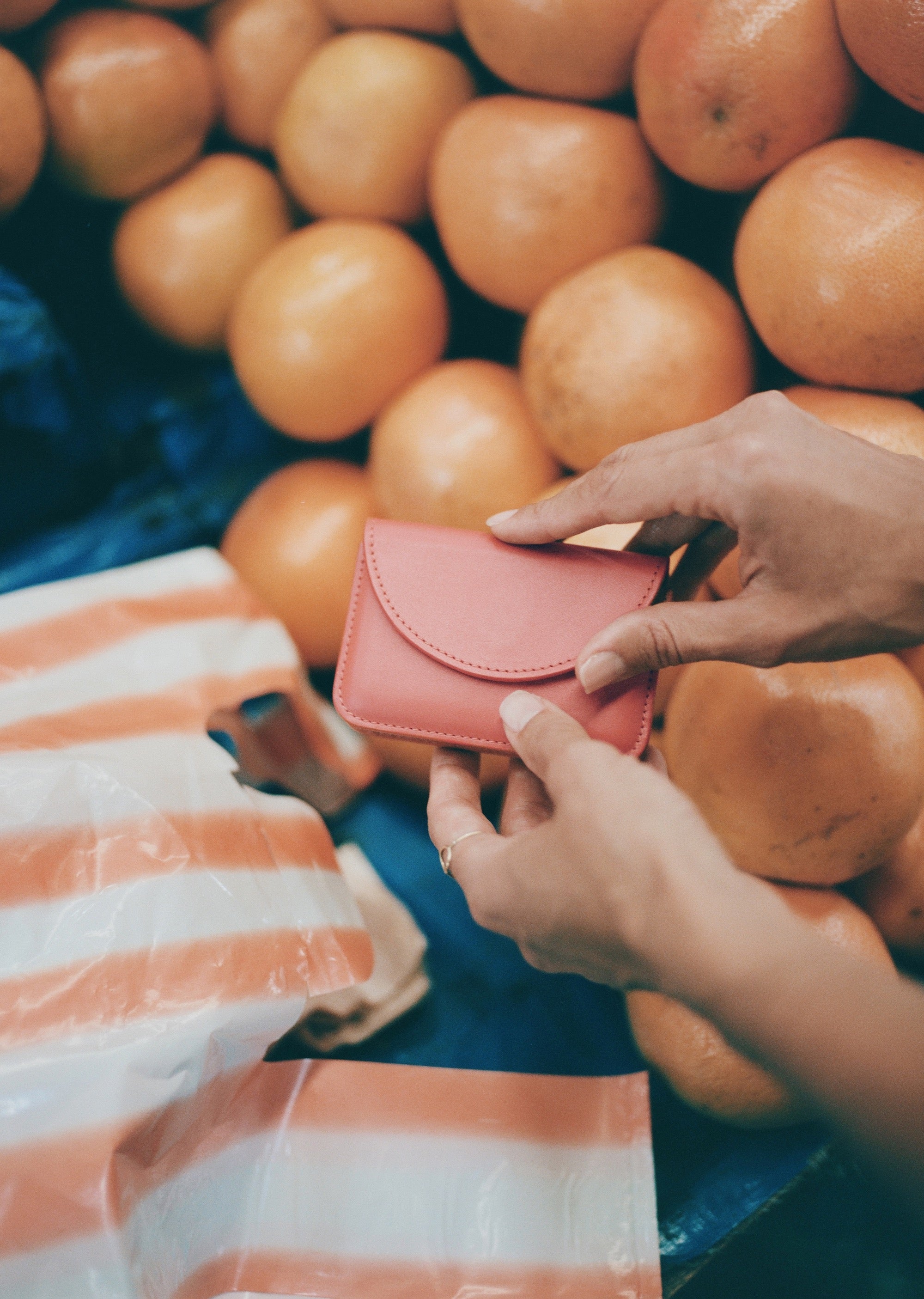 Orange-red, card-sized wallet with envelope-style semicircle flap.