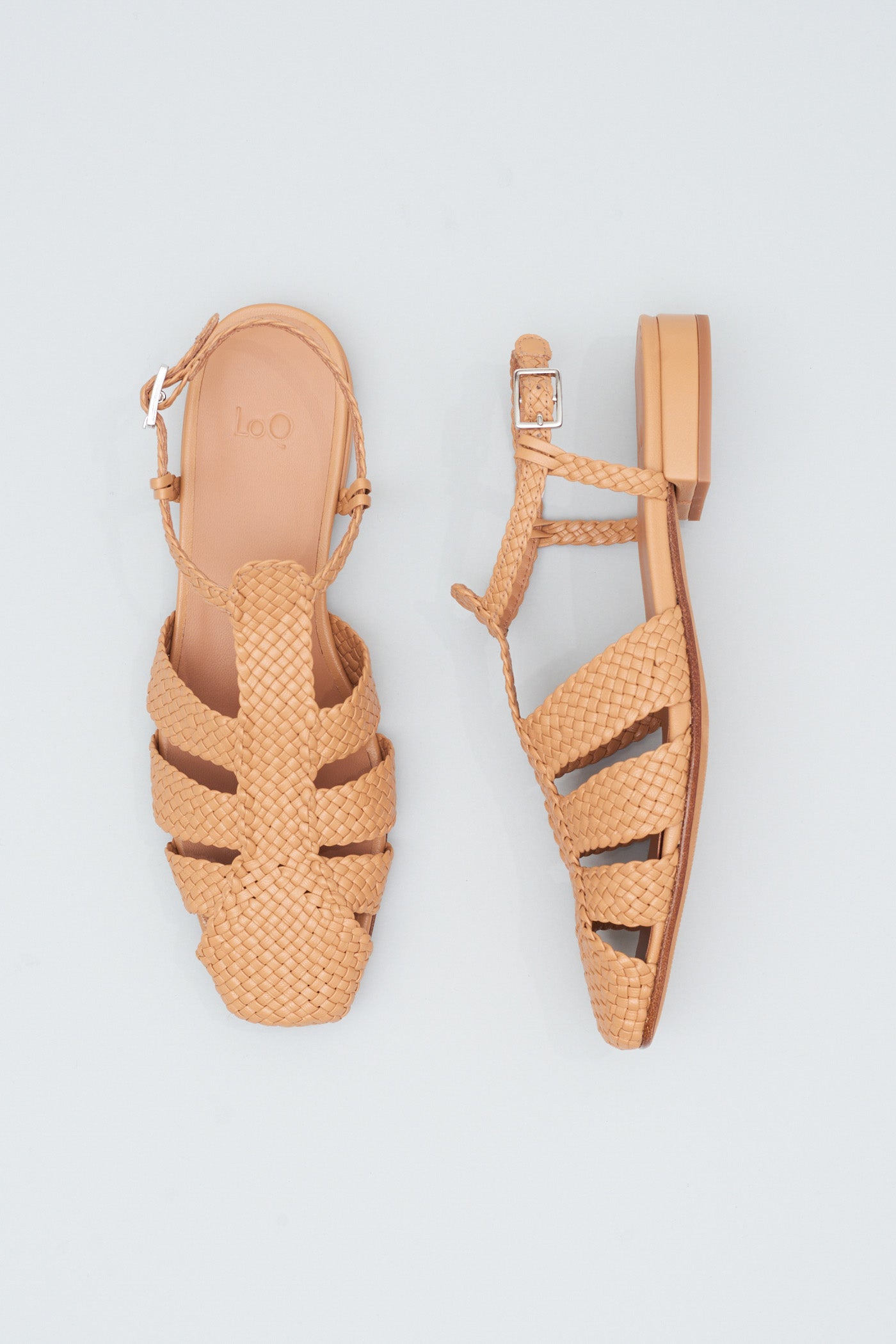 Fisherman-style sandals featuring straps made of woven leather across the foot and a strap that buckles around the ankle