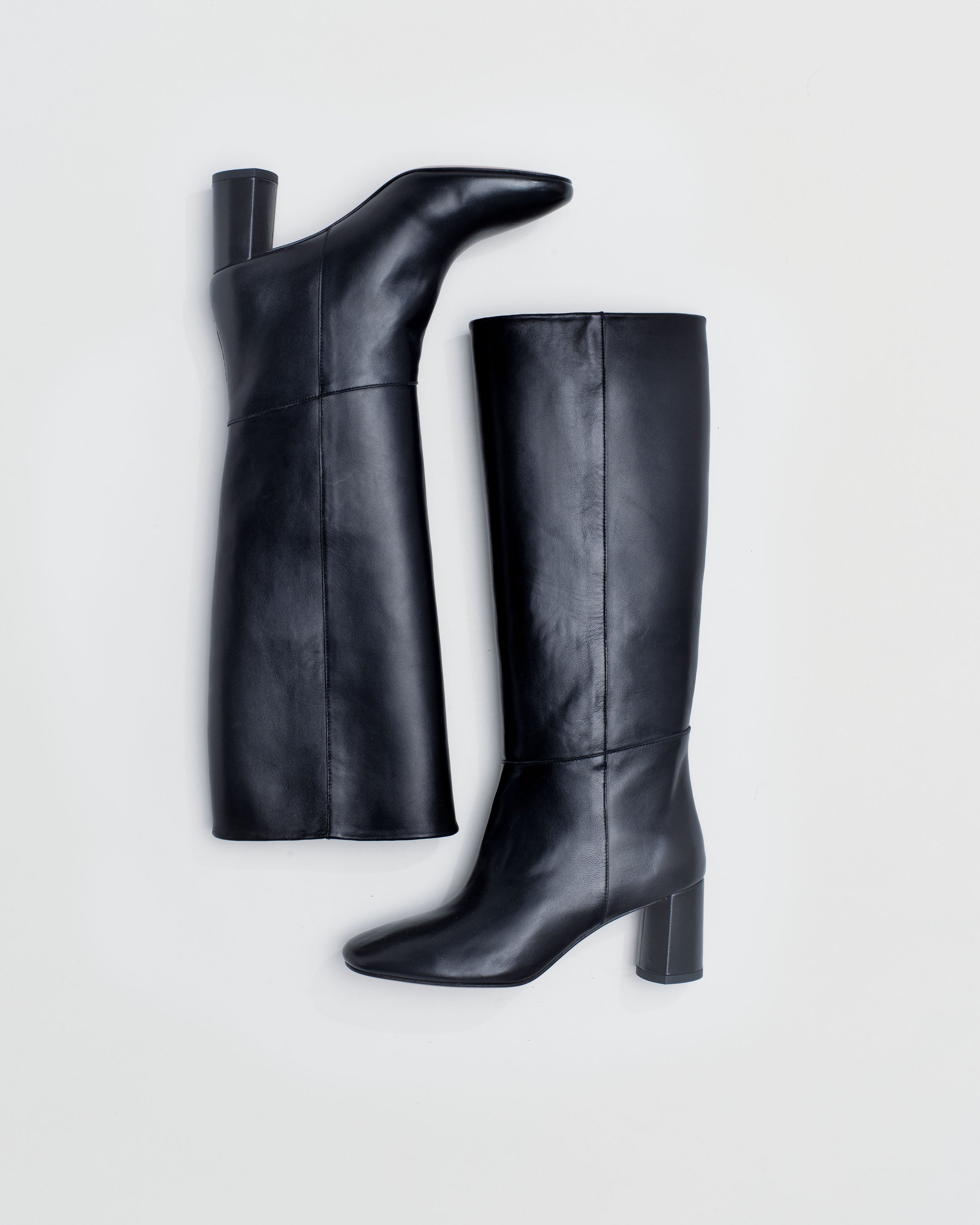 Tall pull-on boot in a supple classic black leather that sits below the knee with a round toe