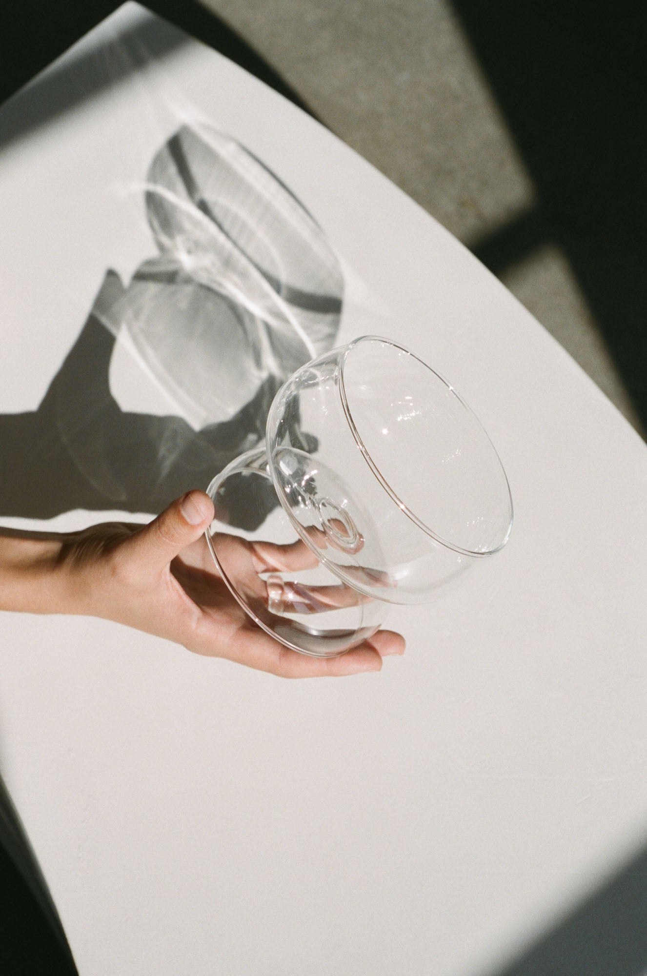 Wide rim cocktail glass with a sculptural statement stem in translucent glass.