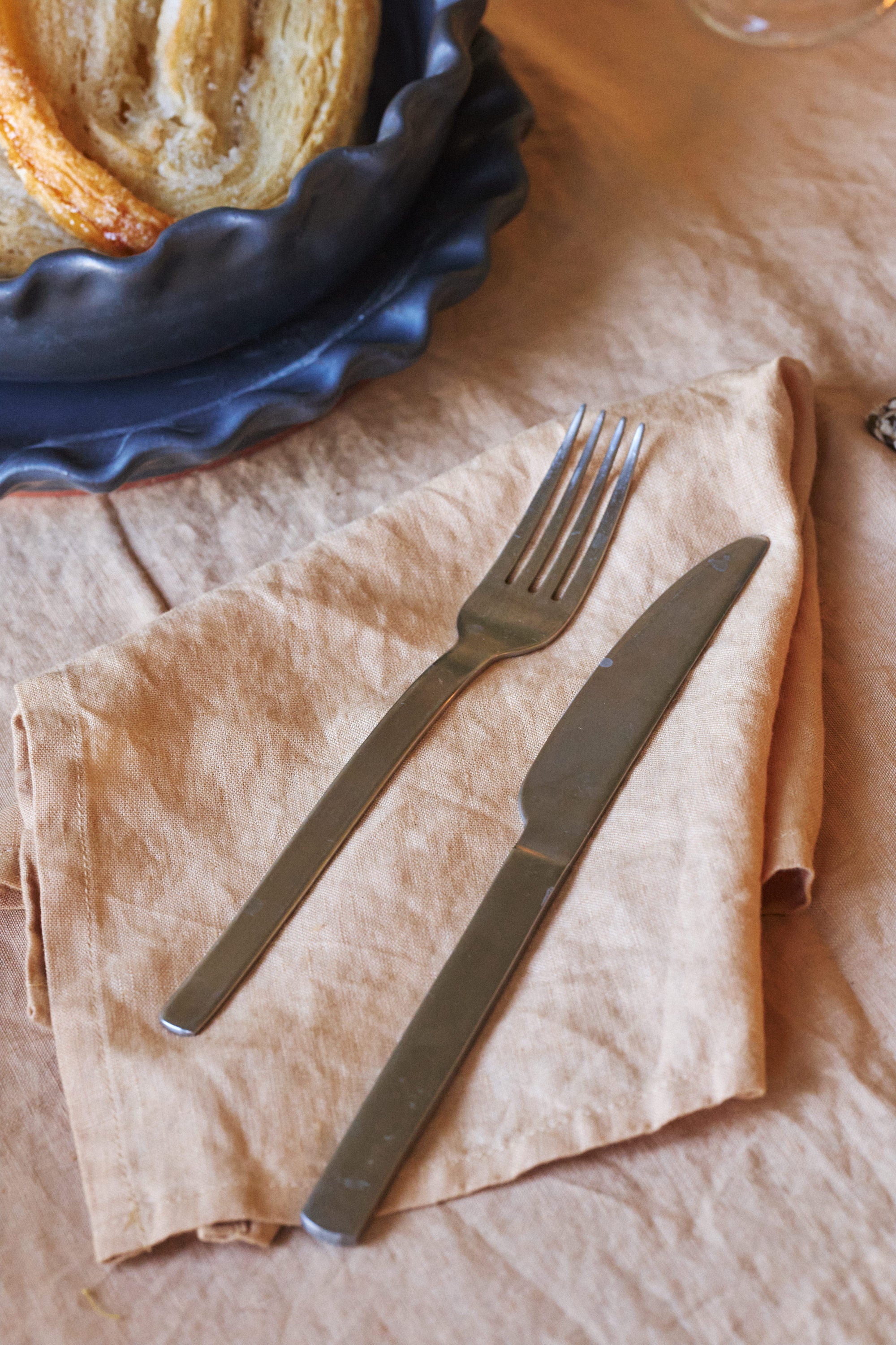 Hand-dyed 100% cotton tussor napkins made by Arles Studio in nut, a light Sienna color. 