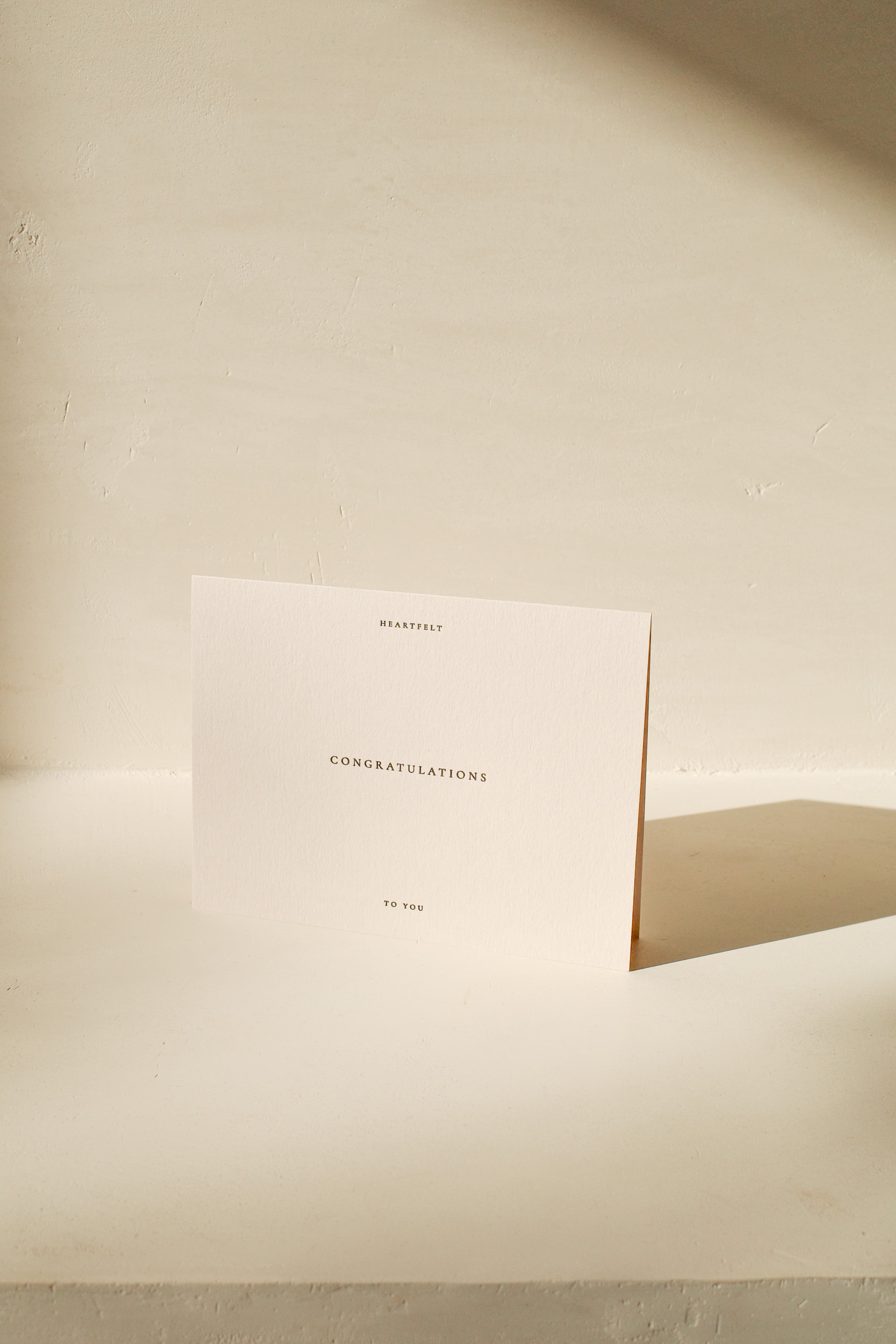 Off white congratulations card that reads: Heartfelt congratulations to you.
