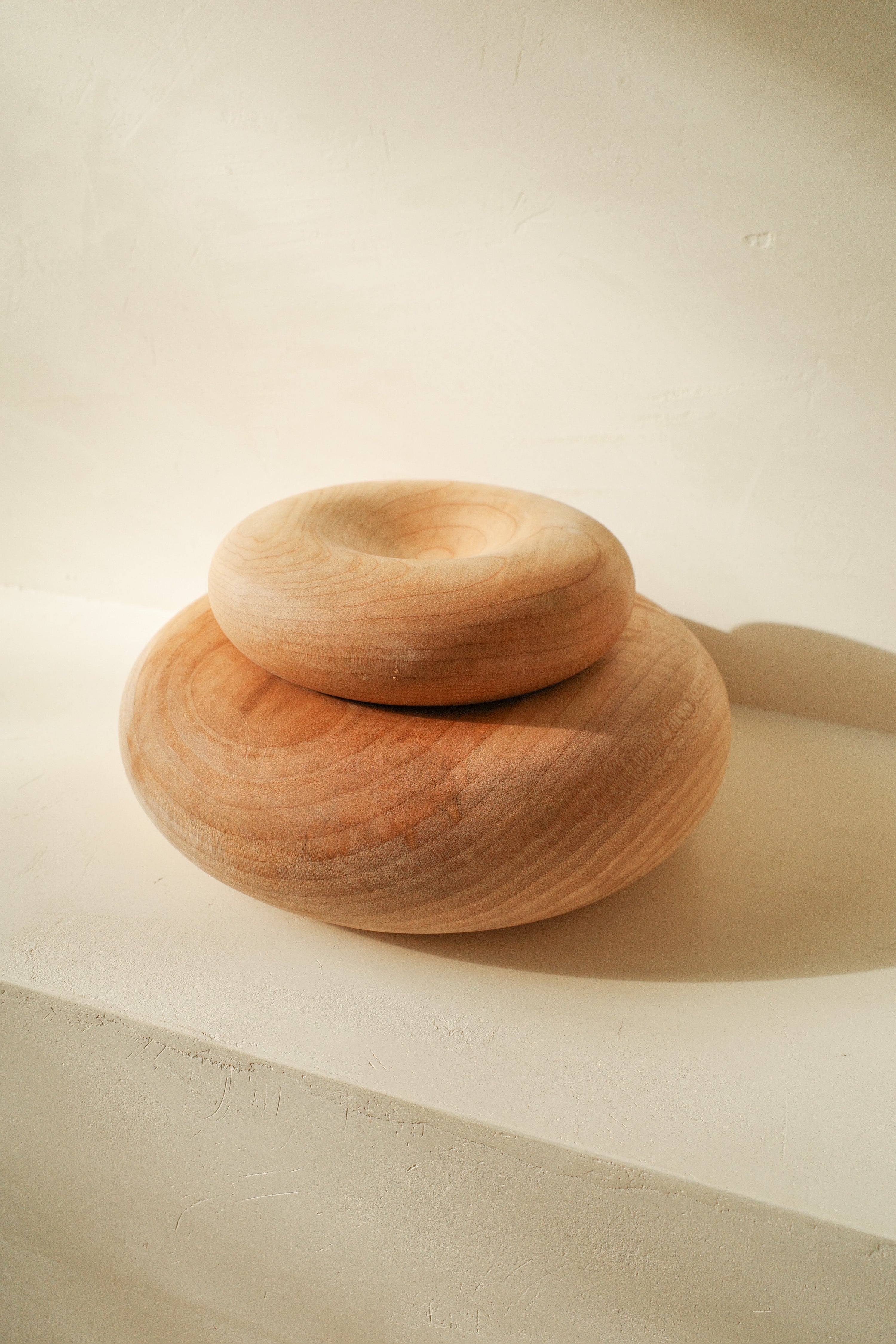 Sculptural donut shaped objects, hand turned with local maple wood.