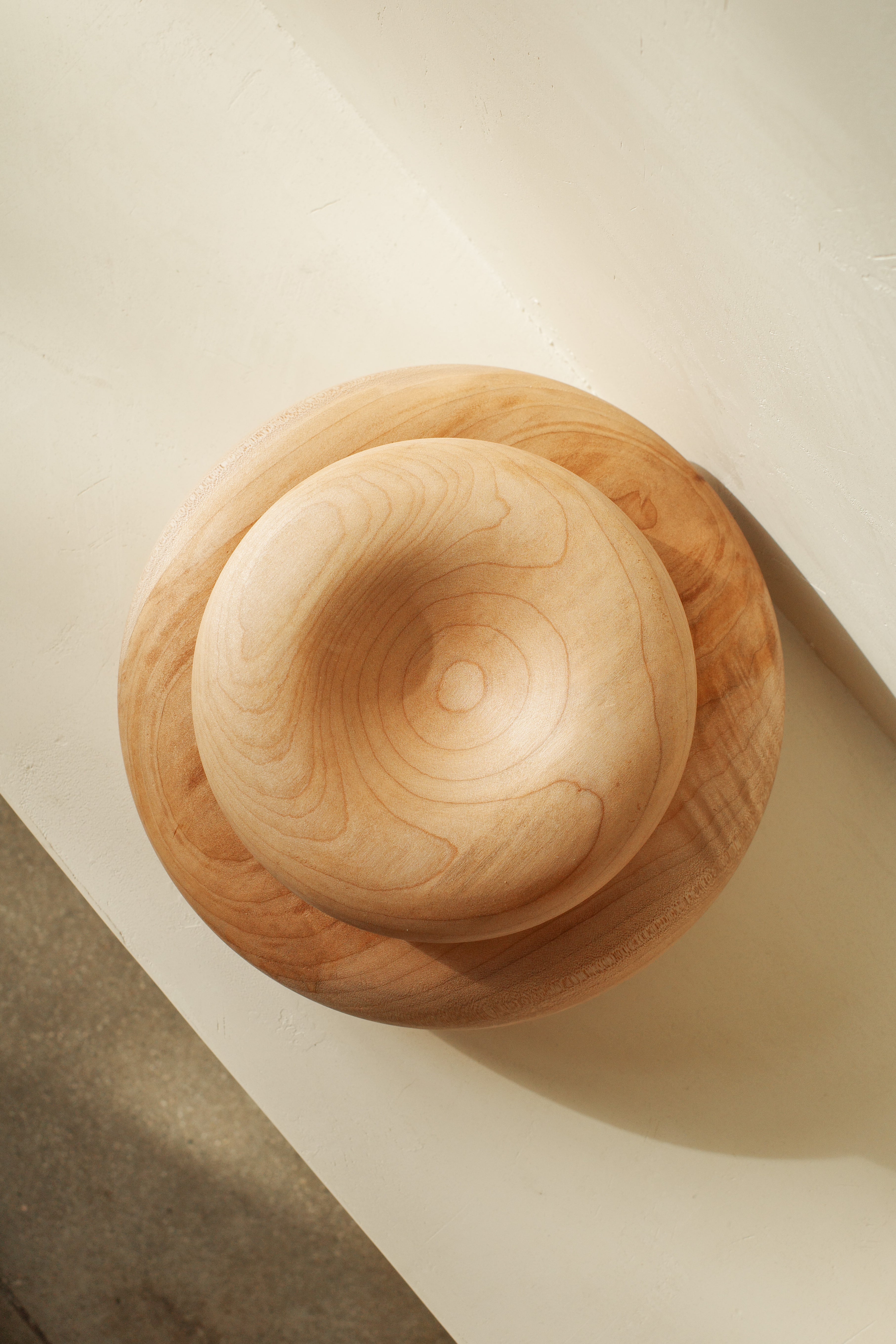 Sculptural donut shaped objects, hand turned with local maple wood.