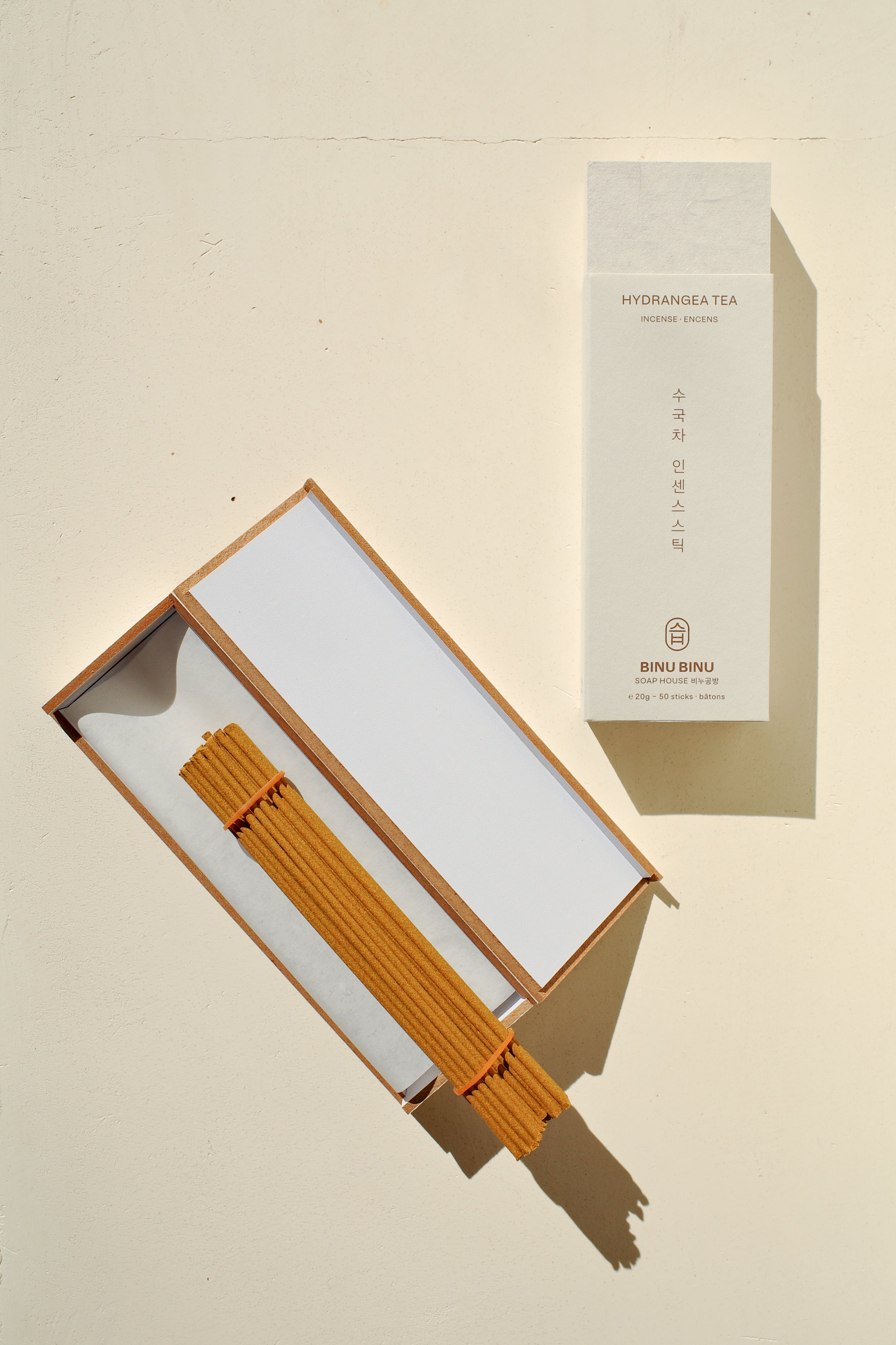 Open box of incense next to packaging.