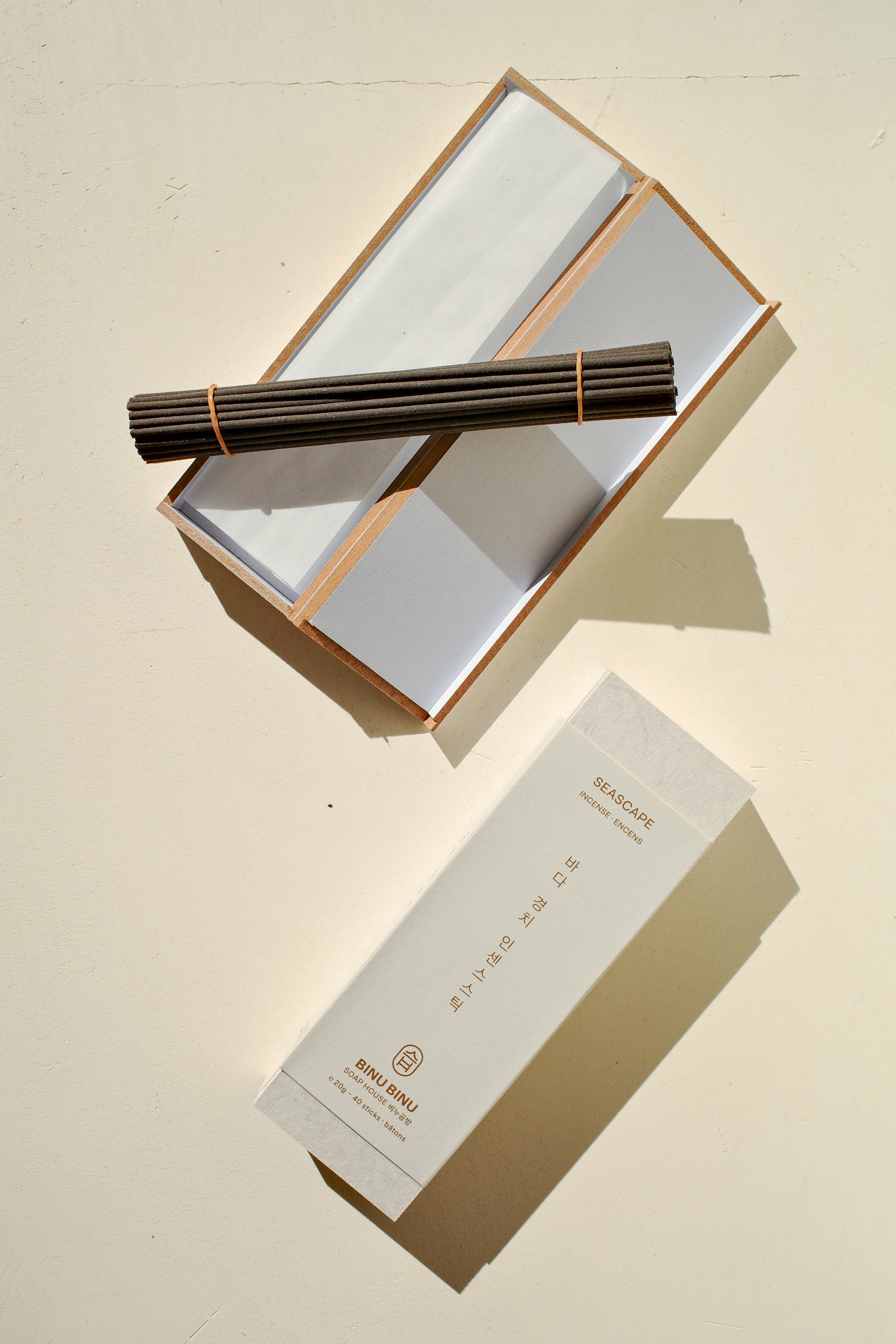 Open box of incense next to packaging.
